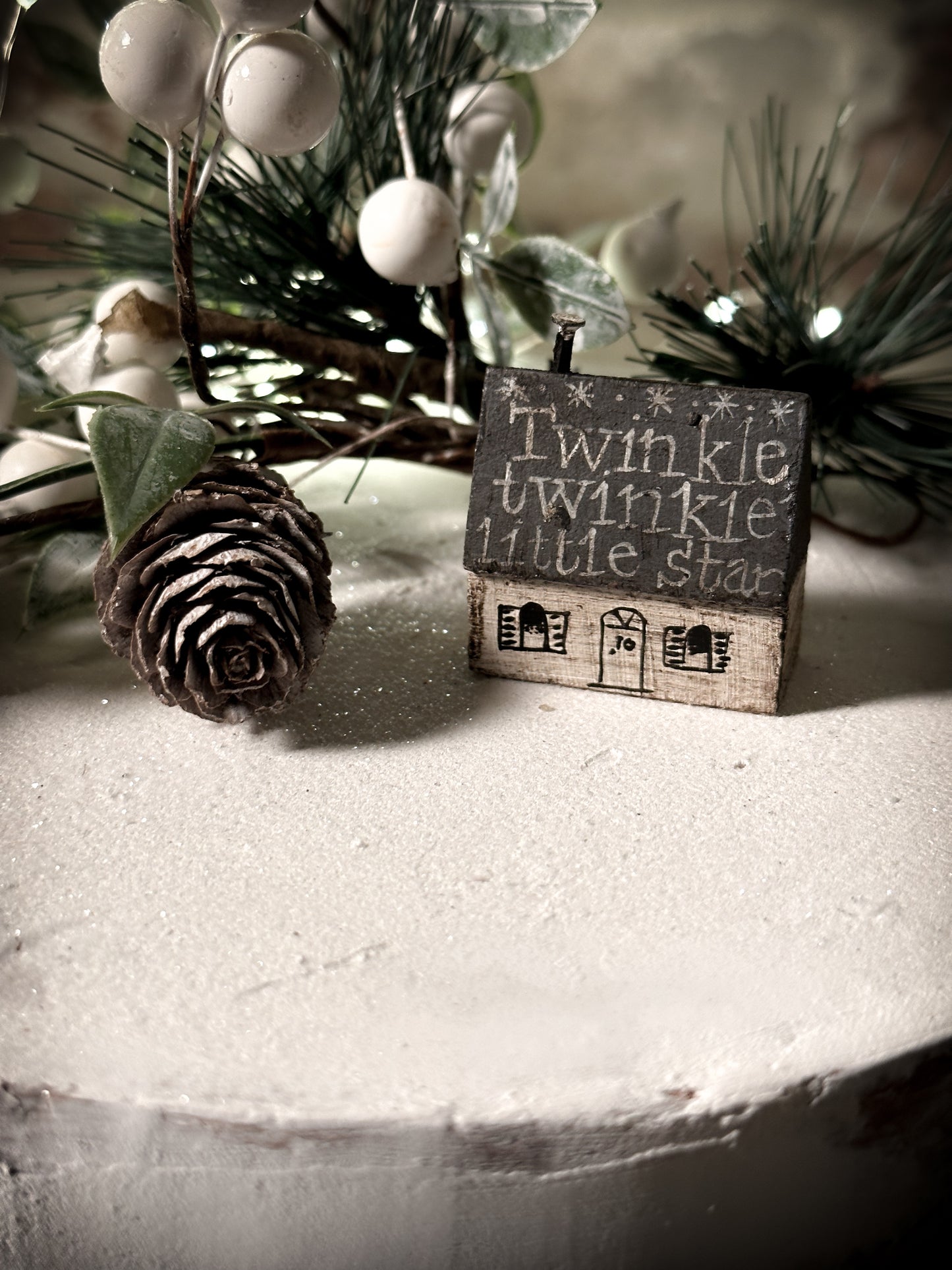 A pretty vintage German Erzgebirge Putz wooden village house painted with a Christmas quote
