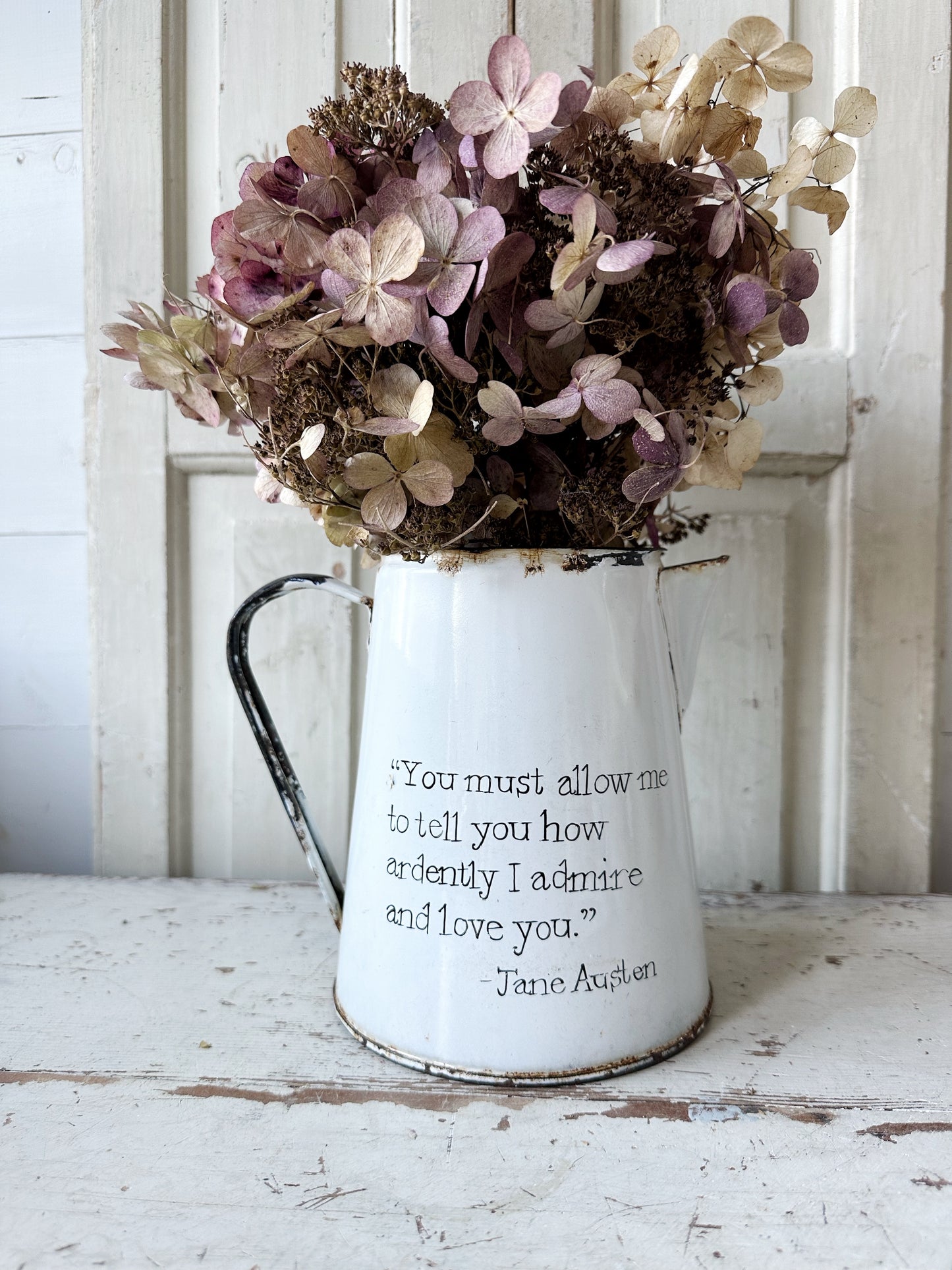 A hand painted quote on a beautiful Vintage white enamelware jug