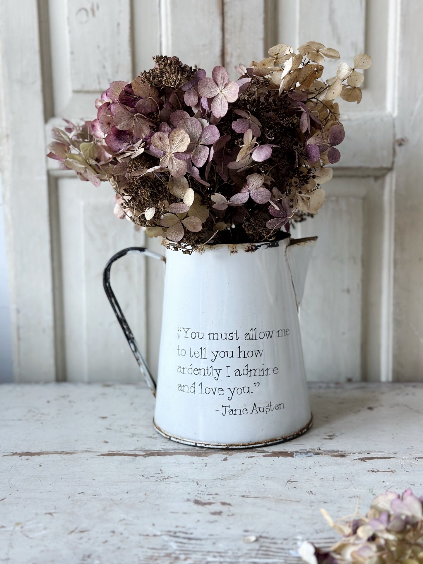 A hand painted quote on a beautiful Vintage white enamelware jug