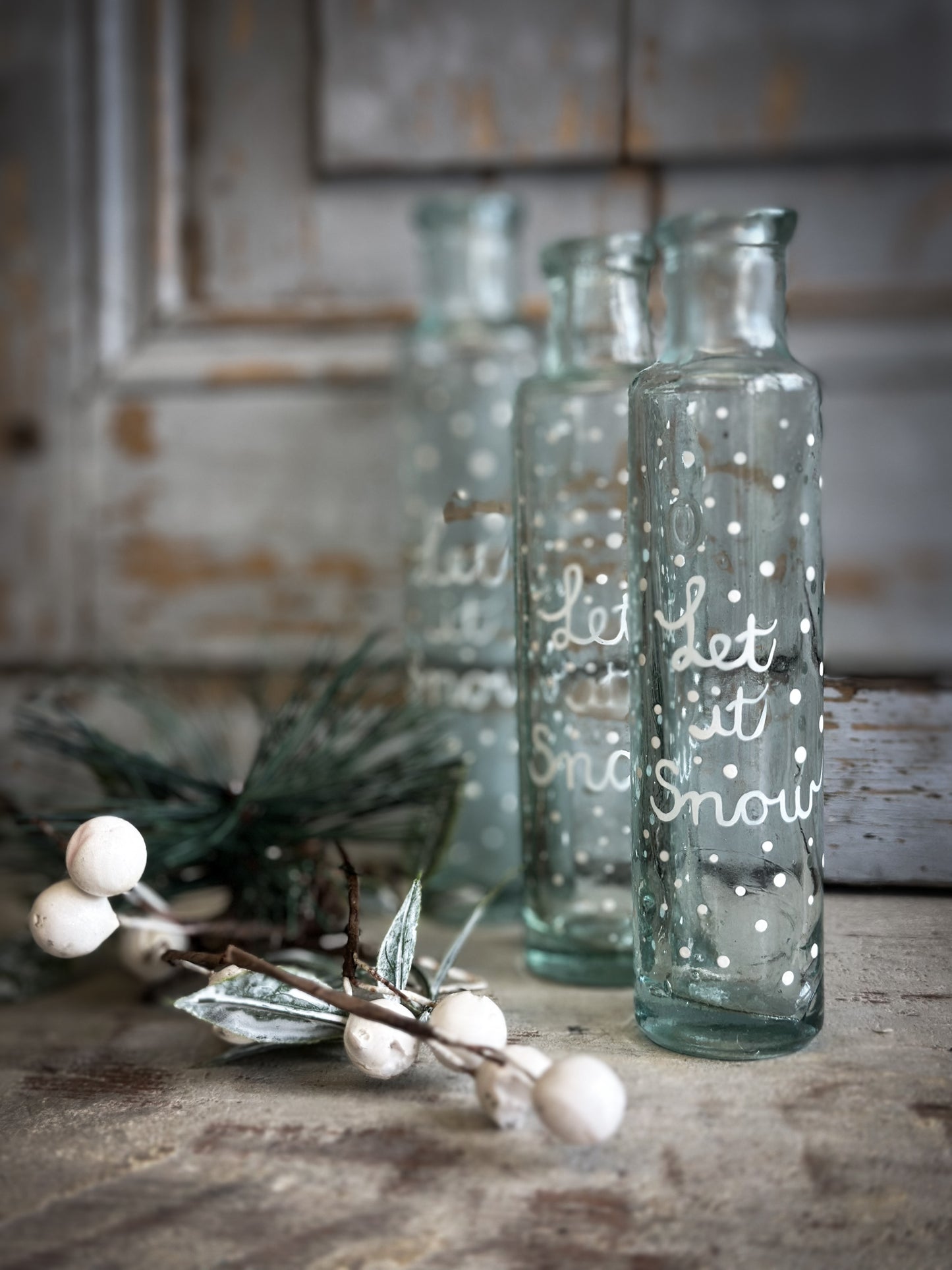 A beautiful Victorian cylinder bottle painted with a Christmas quote “Let it Snow”