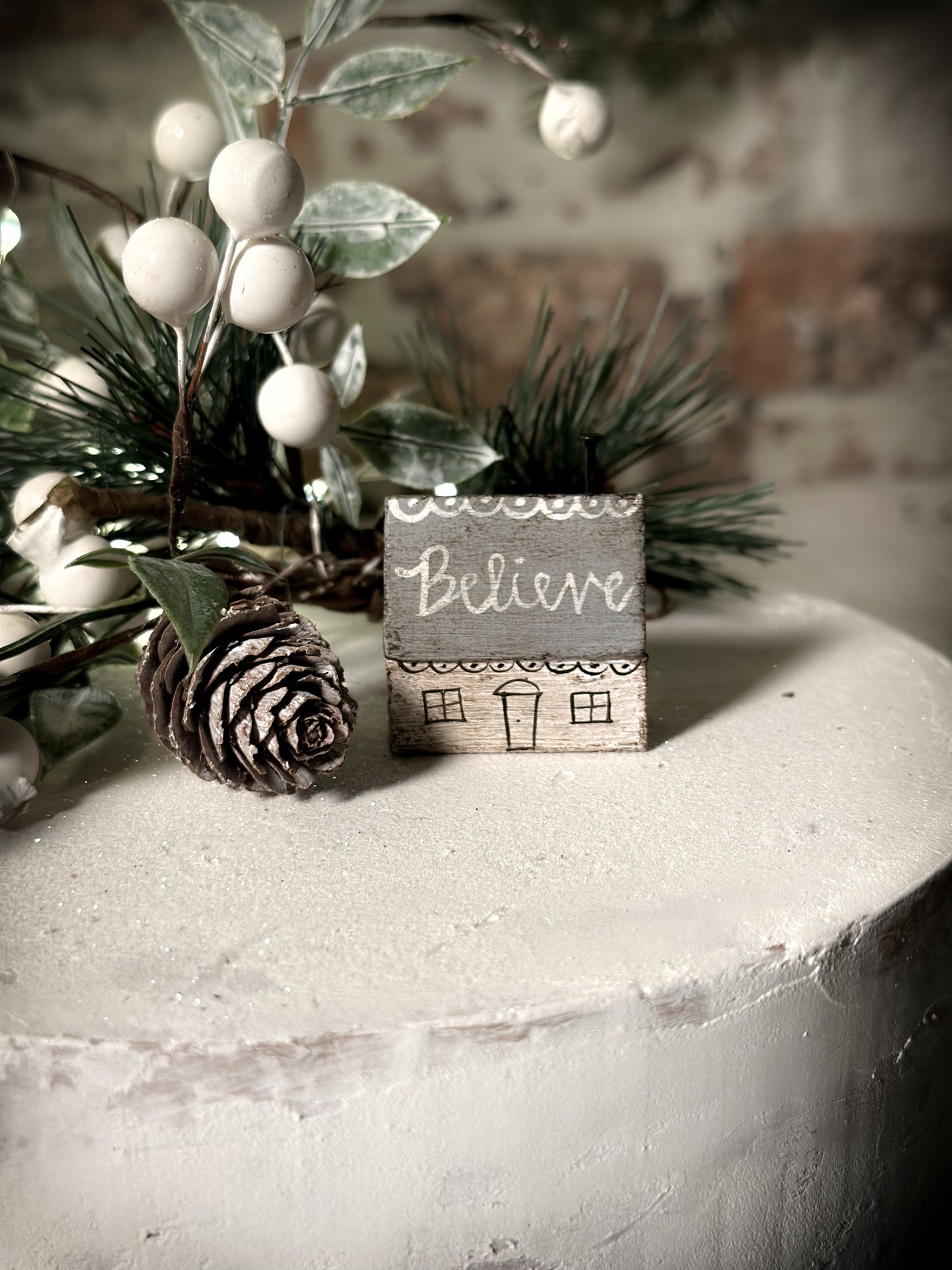 A pretty vintage German Erzgebirge Putz wooden village house painted with a Christmas quote