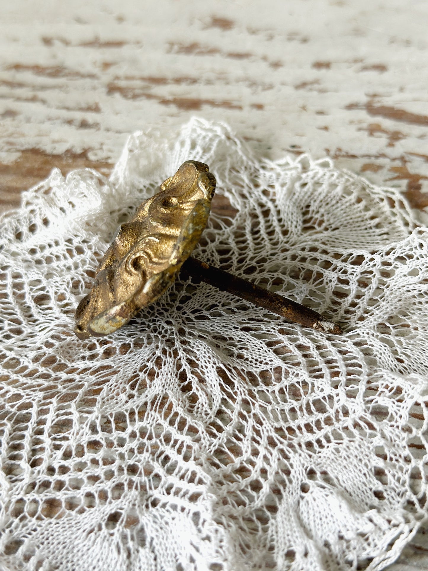 A pair of antique brass salvaged French curtain tie back hooks