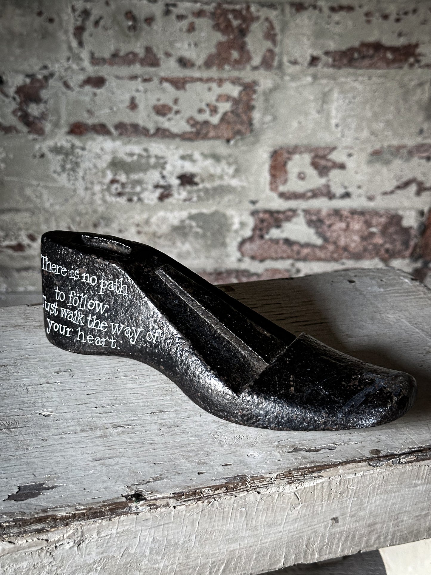 An antique cast iron painted adult’s shoe last.
