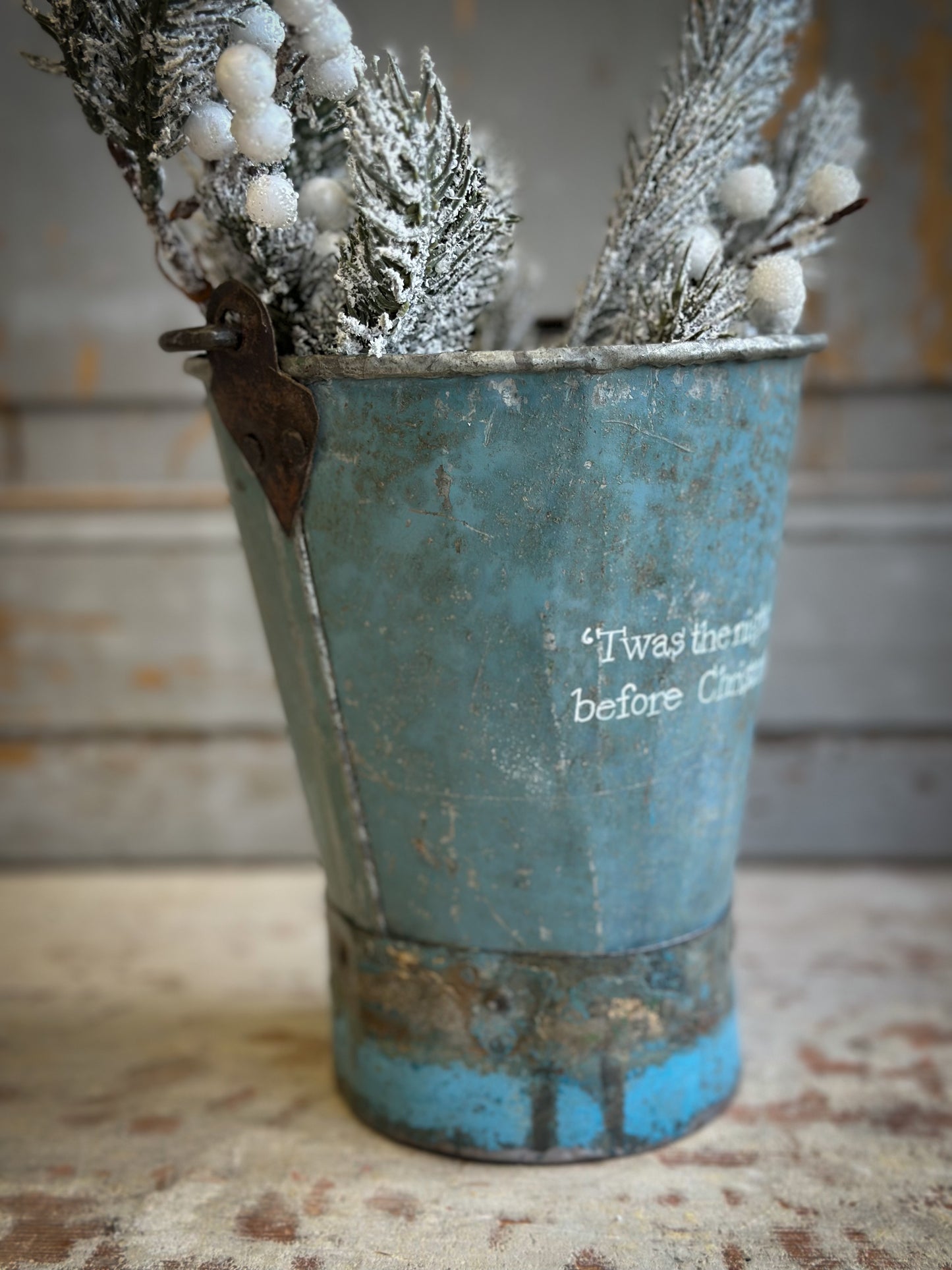 A Recycled Metal Mini Christmas Tree Bucket With A Hand Painted Quote