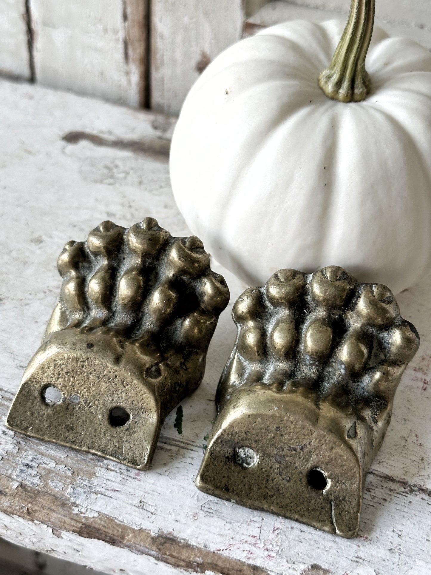 A pair of two antique brass salvaged clawed feet for furniture