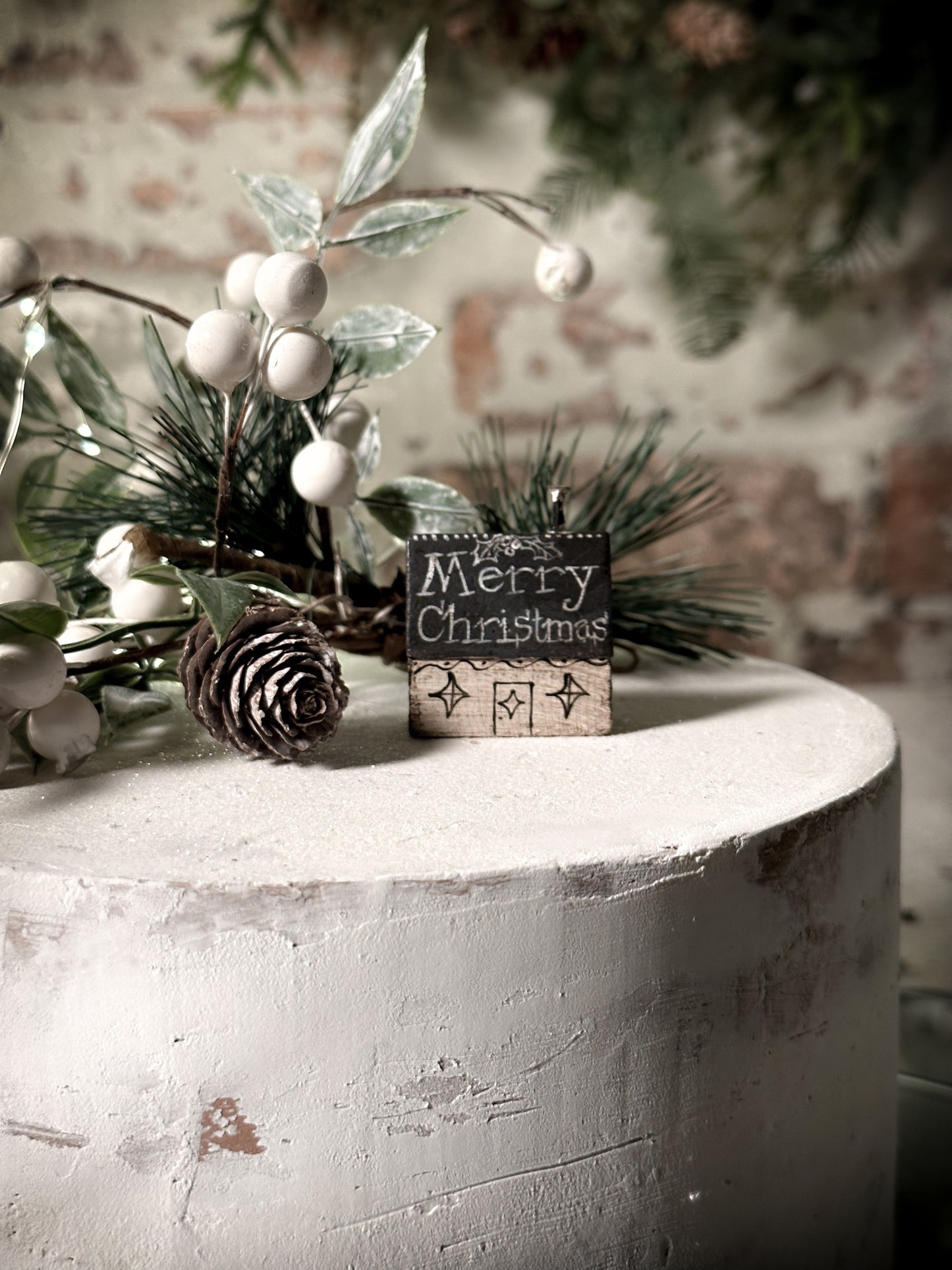 A pretty vintage German Erzgebirge Putz wooden village house painted with a Christmas quote