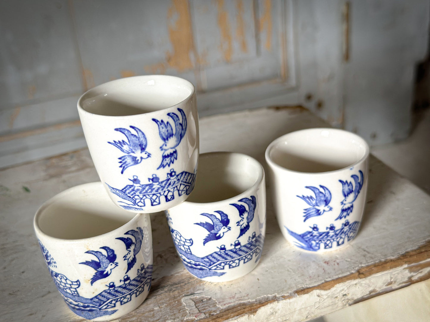 A set of four pretty Staffordshire pottery blue and white Willow Pattern egg cups