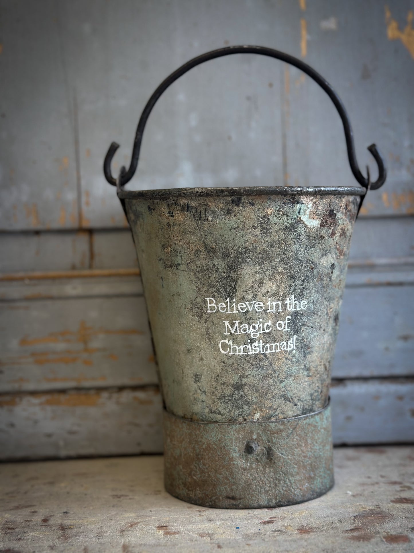 A Recycled Metal Mini Christmas Tree Bucket With A Hand Painted Quote
