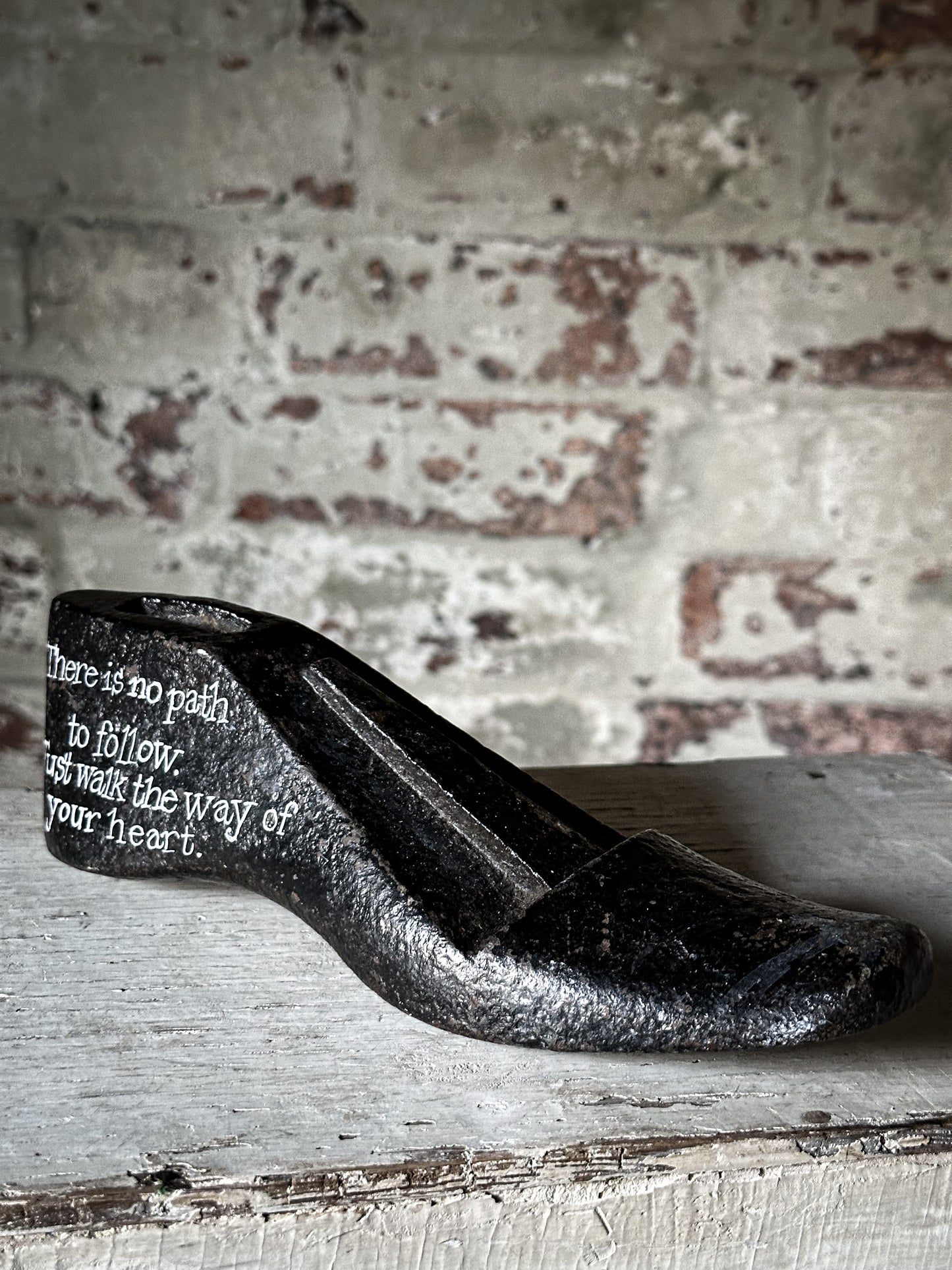 An antique cast iron painted adult’s shoe last.