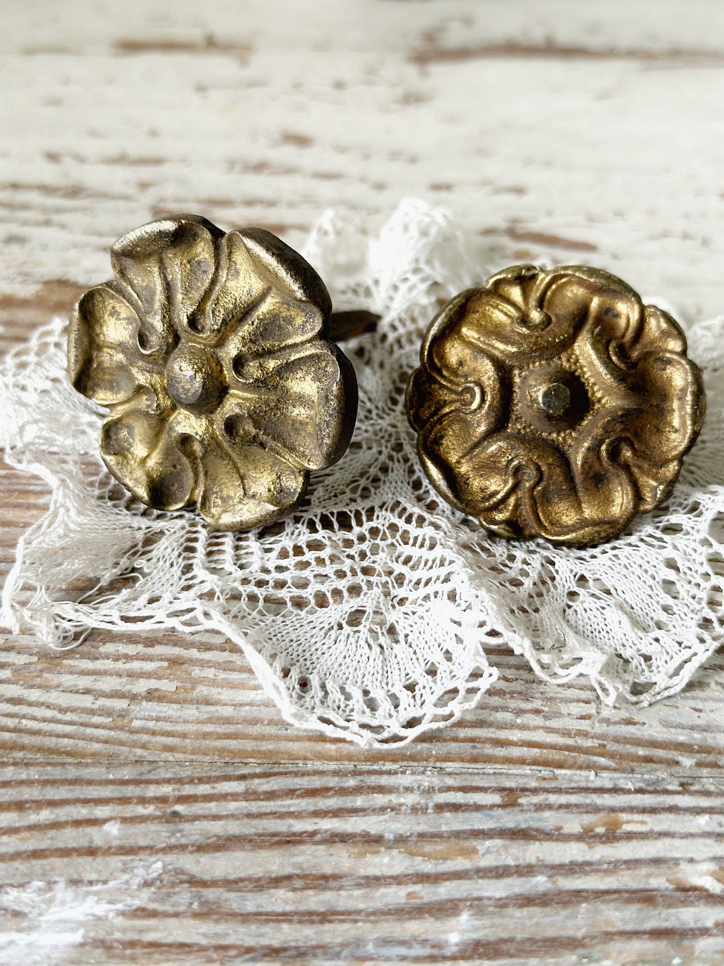 A pair of antique brass salvaged French curtain tie back hooks