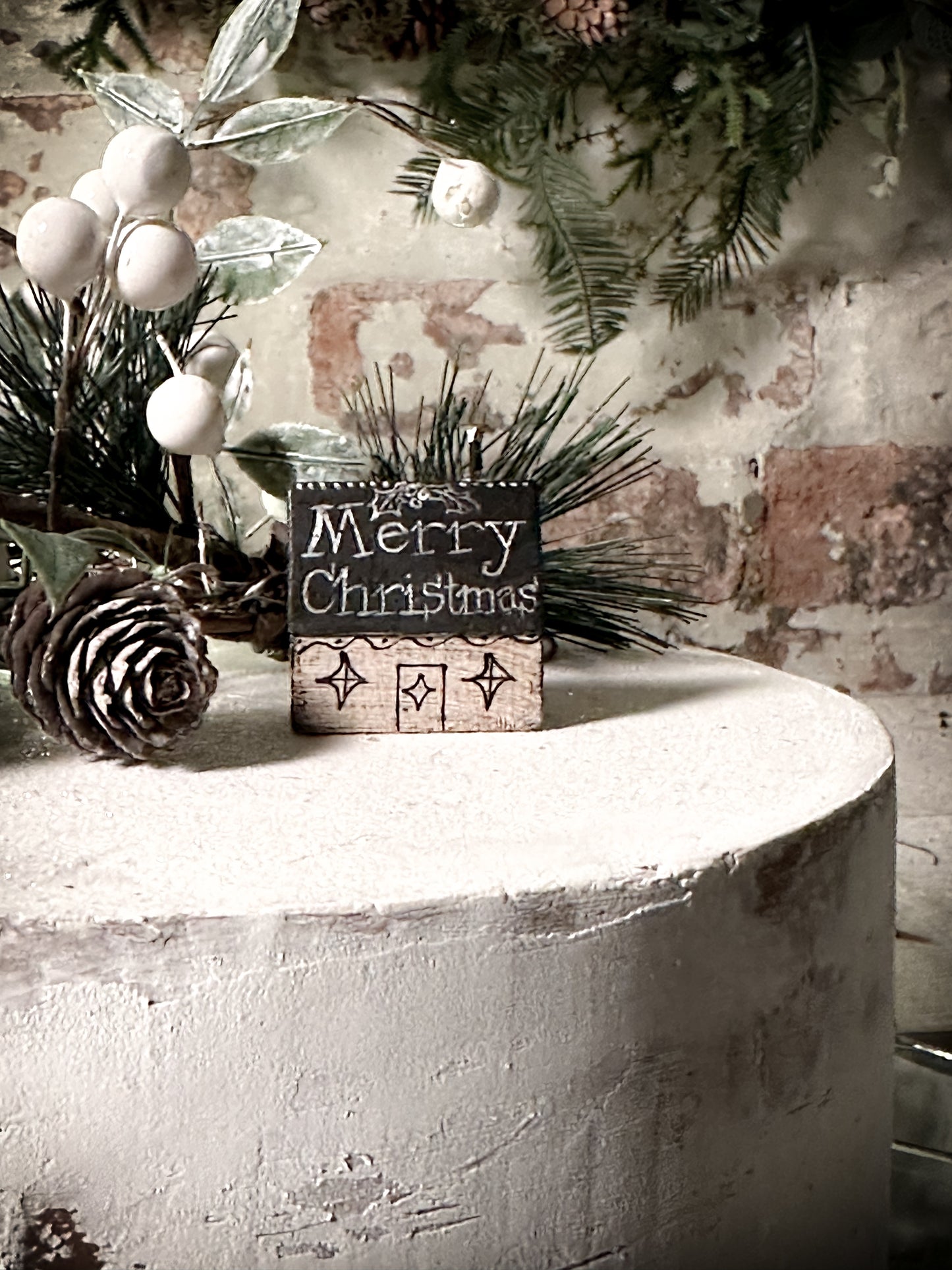 A pretty vintage German Erzgebirge Putz wooden village house painted with a Christmas quote