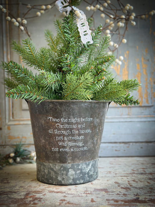 A Recycled Metal Small Christmas Tree Bucket With A Hand Painted Quote