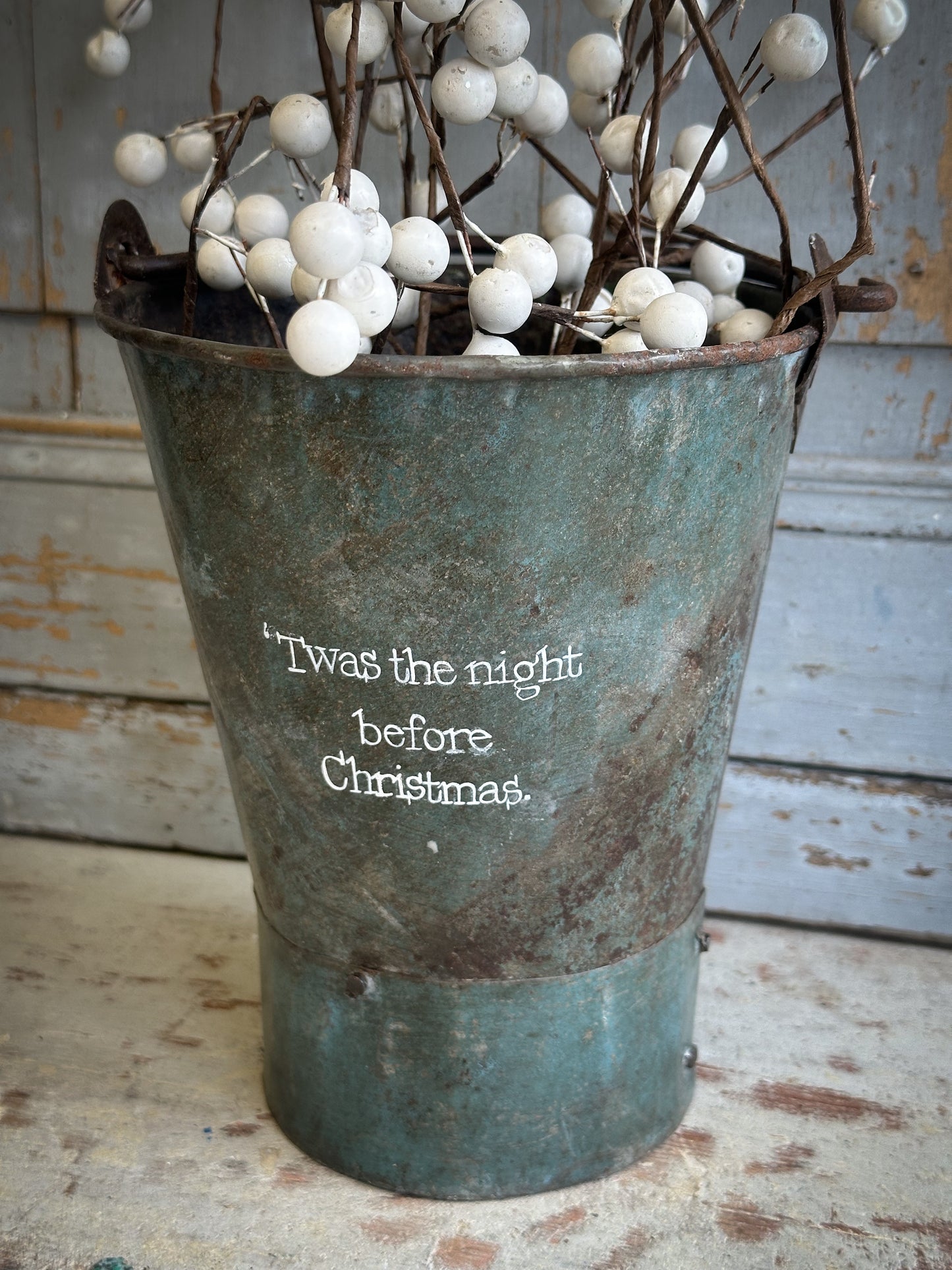 A Recycled Metal Mini Christmas Tree Bucket With A Hand Painted Quote