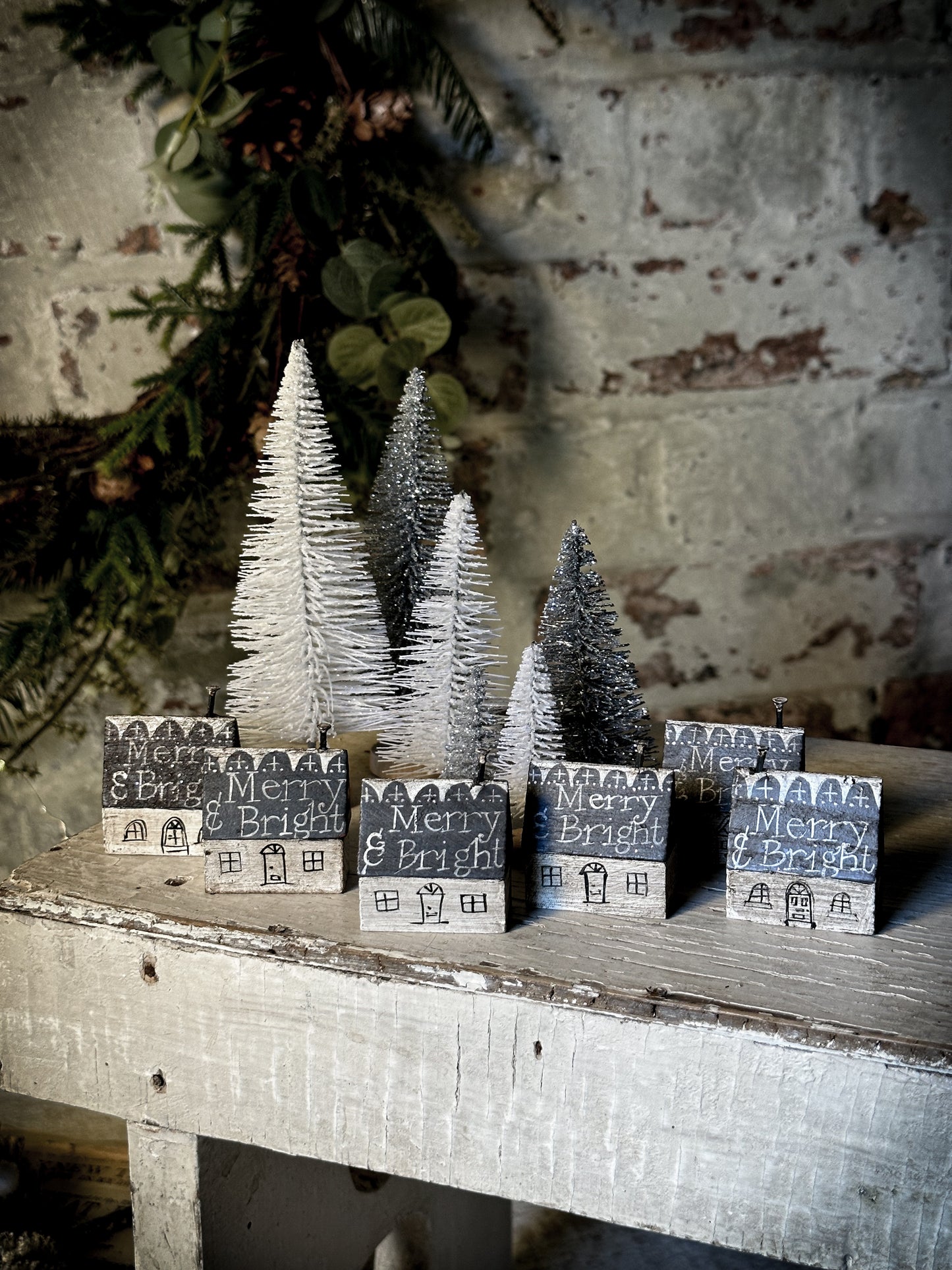 A pretty vintage German Erzgebirge Putz wooden village house painted with a Christmas quote