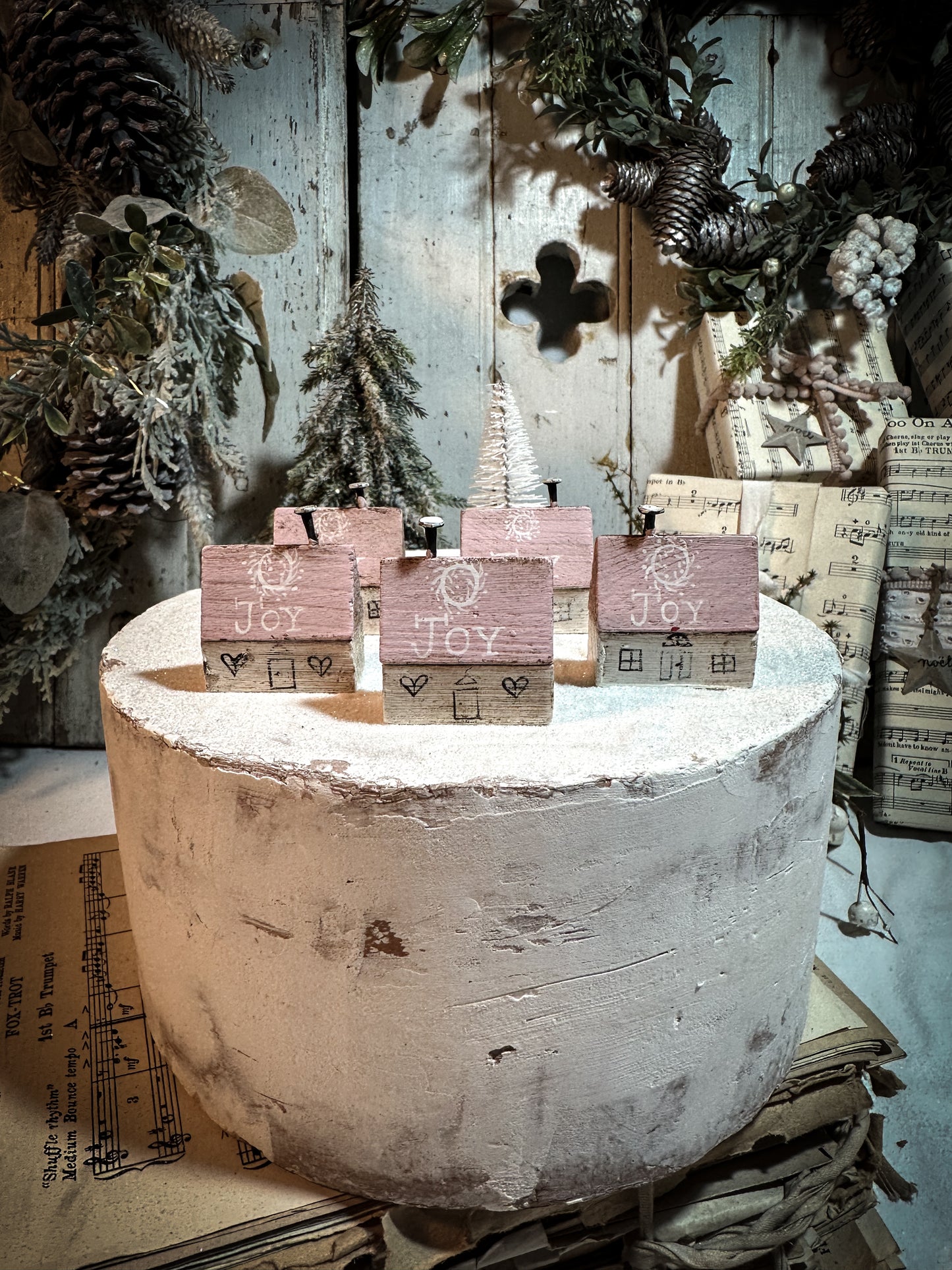 A pretty vintage German Erzgebirge Putz wooden village house painted with a Christmas quote