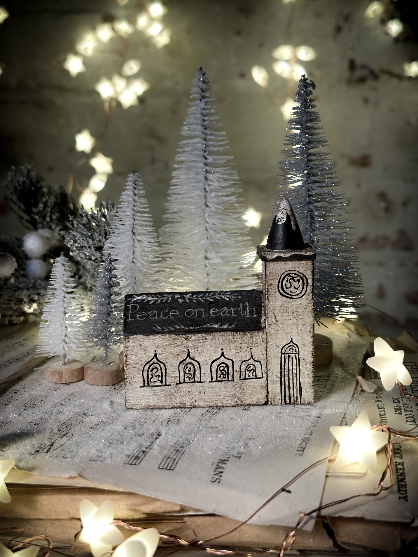 A pretty vintage German Erzgebirge Putz wooden village house painted with a Christmas quote