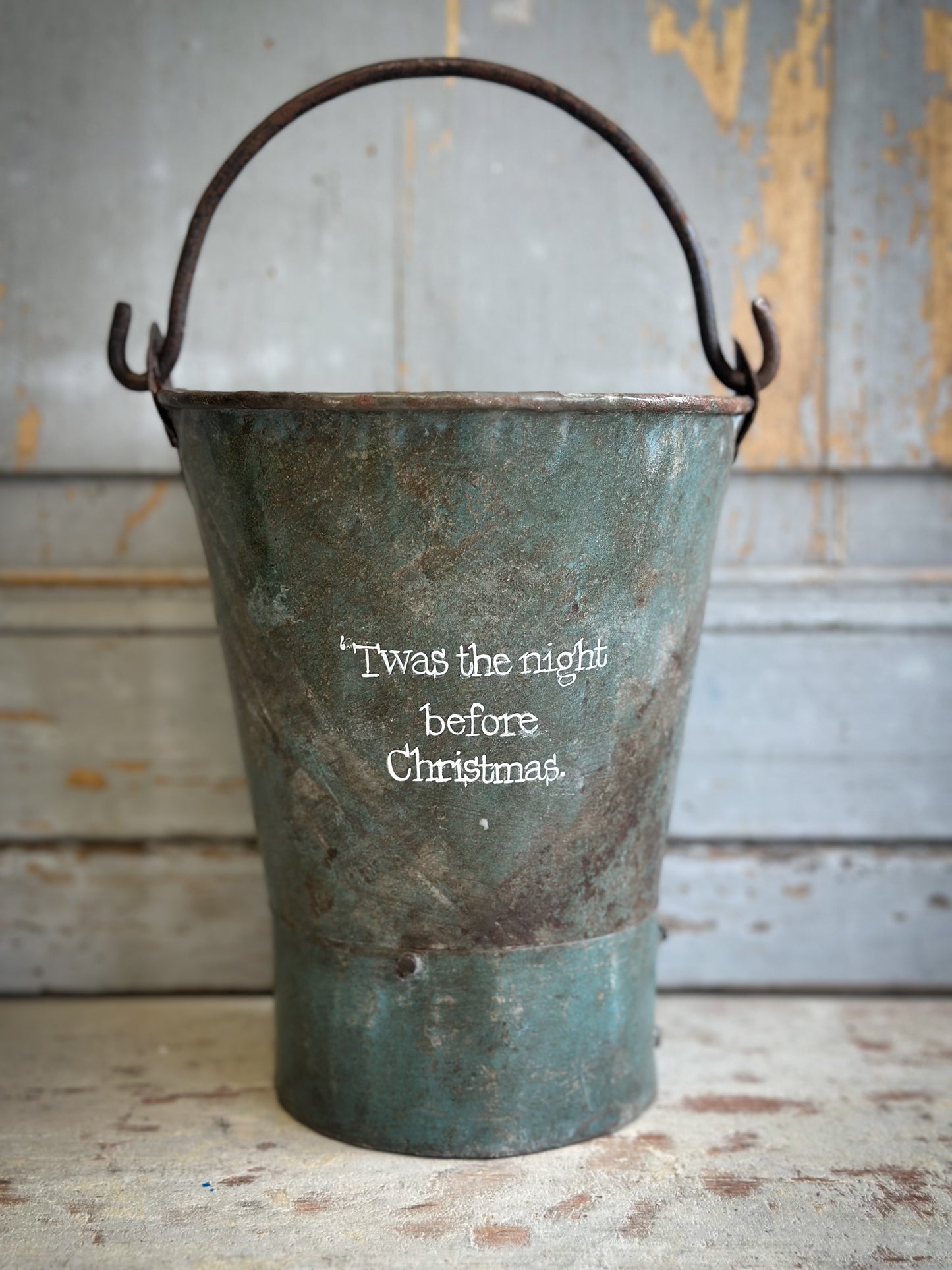A Recycled Metal Mini Christmas Tree Bucket With A Hand Painted Quote
