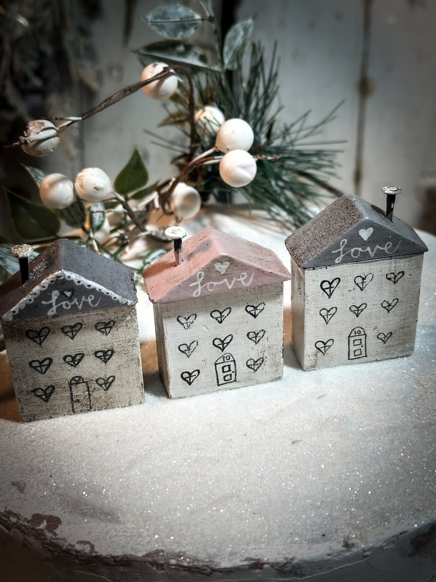A pretty vintage German Erzgebirge Putz wooden village house painted with a Christmas quote