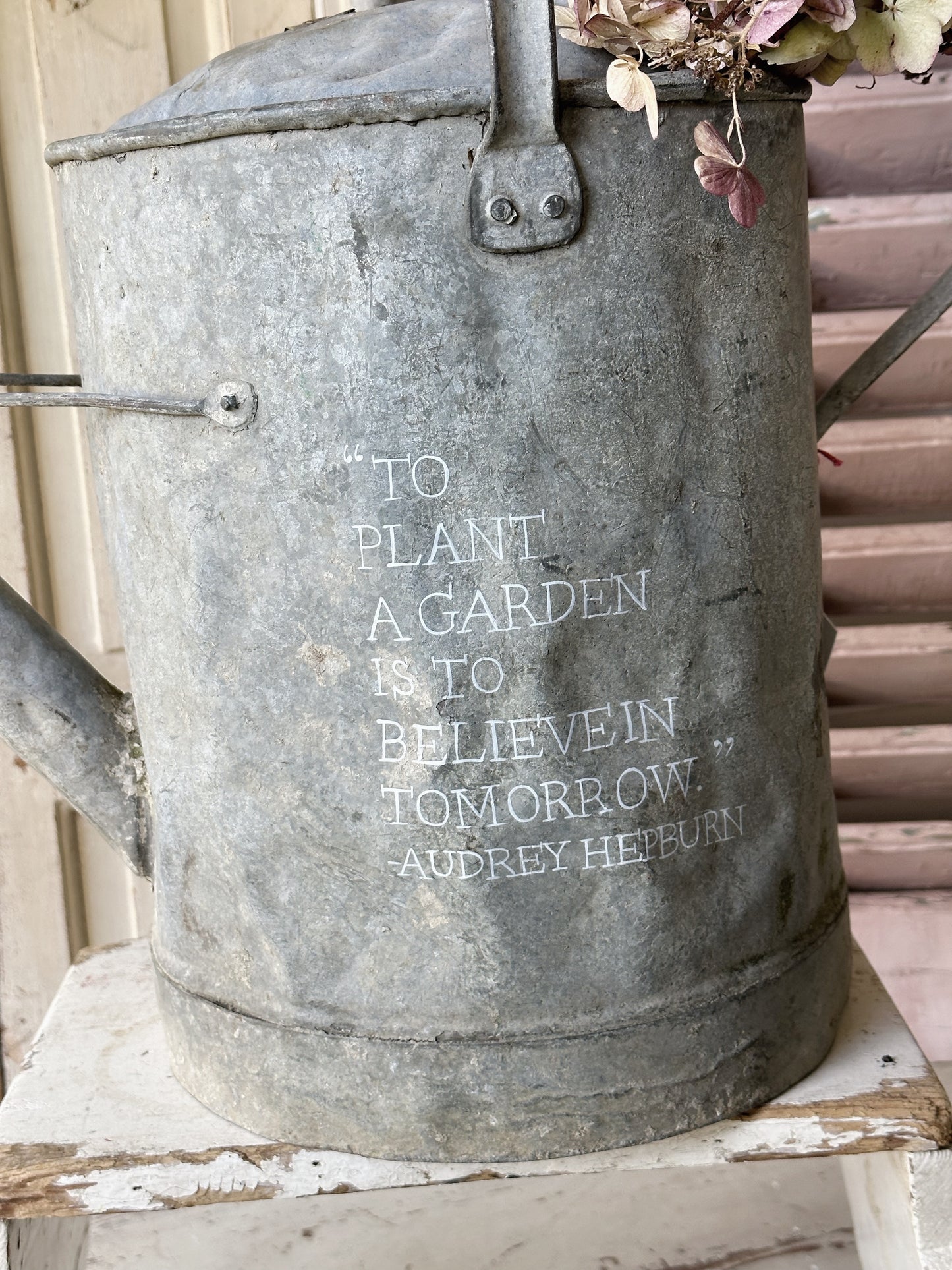 A beautiful vintage galvanised watering can planter