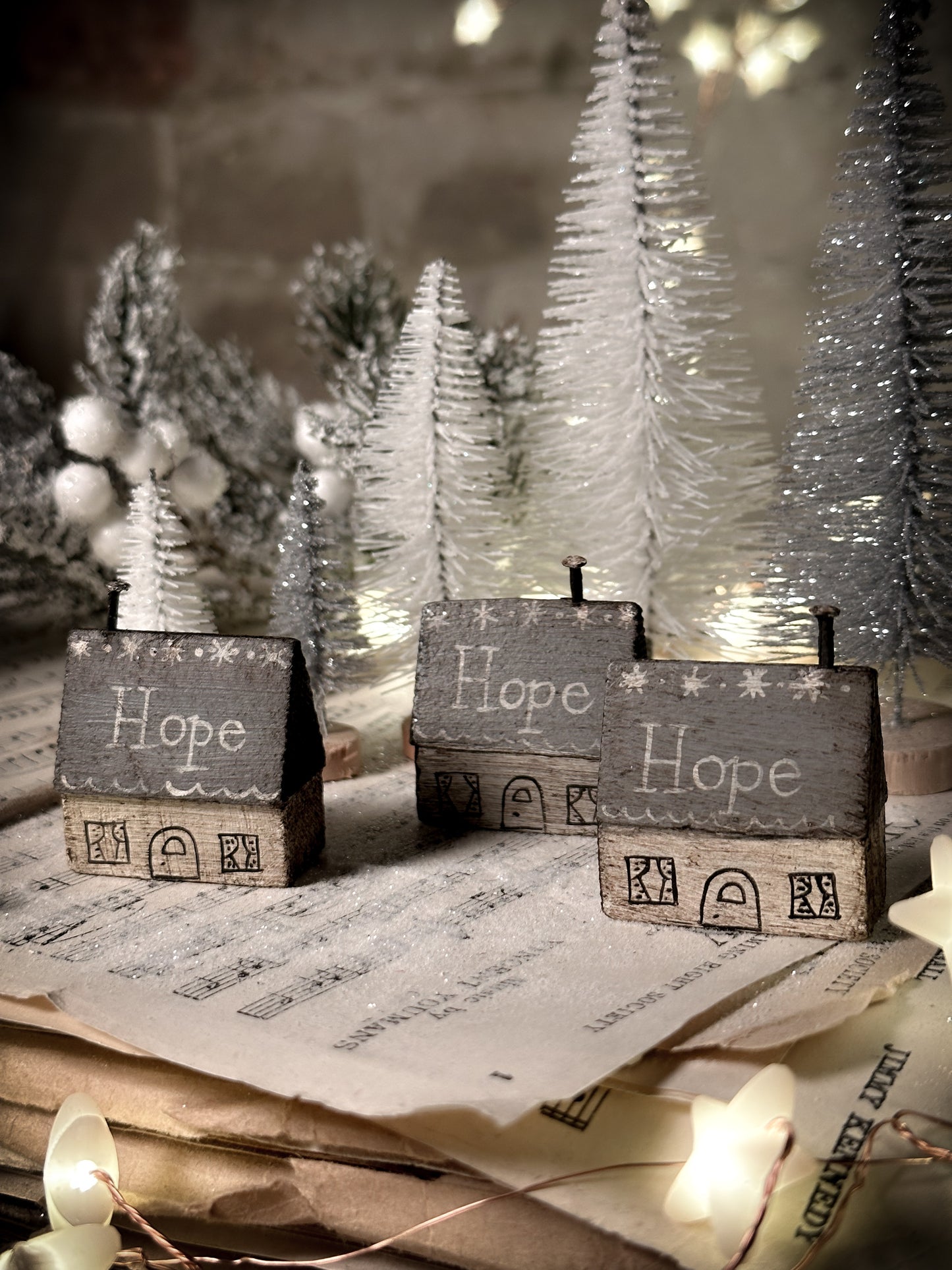 A pretty vintage German Erzgebirge Putz wooden village house painted with a Christmas quote