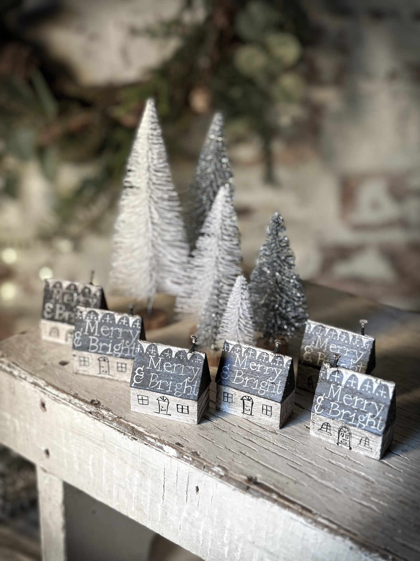 A pretty vintage German Erzgebirge Putz wooden village house painted with a Christmas quote