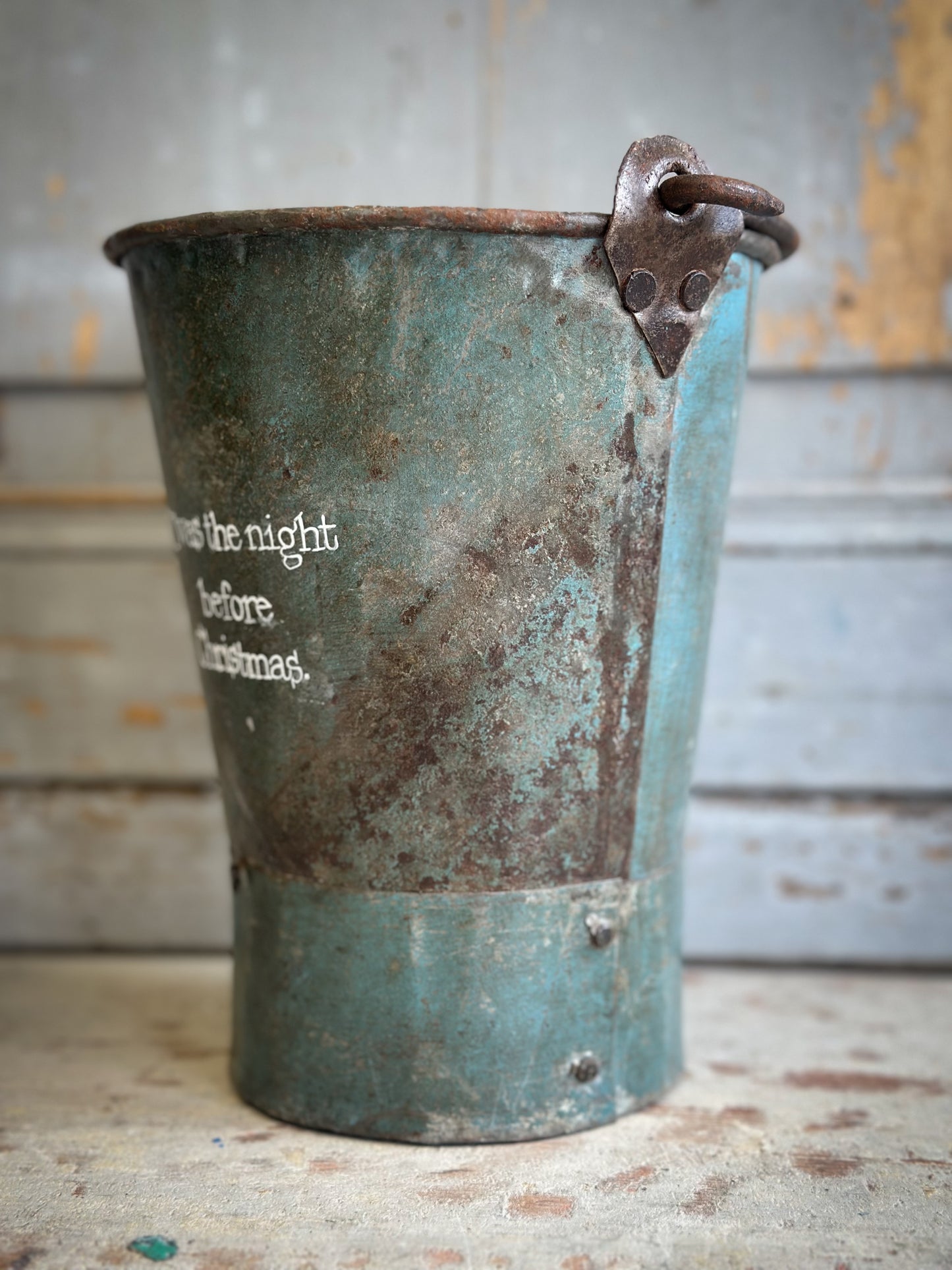 A Recycled Metal Mini Christmas Tree Bucket With A Hand Painted Quote