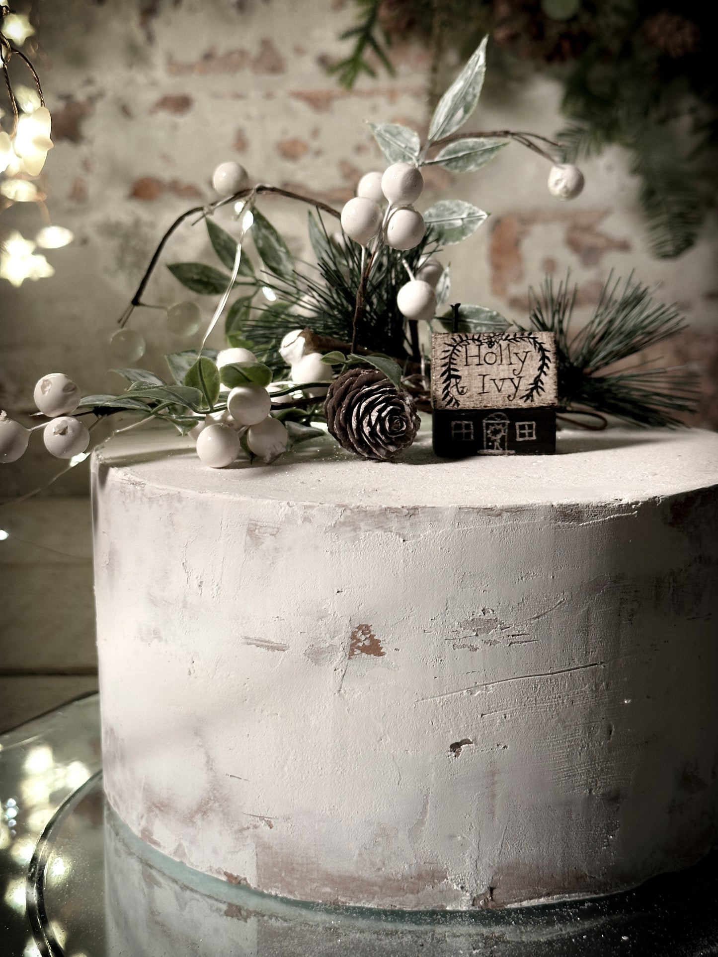 A pretty vintage German Erzgebirge Putz wooden village house painted with a Christmas quote