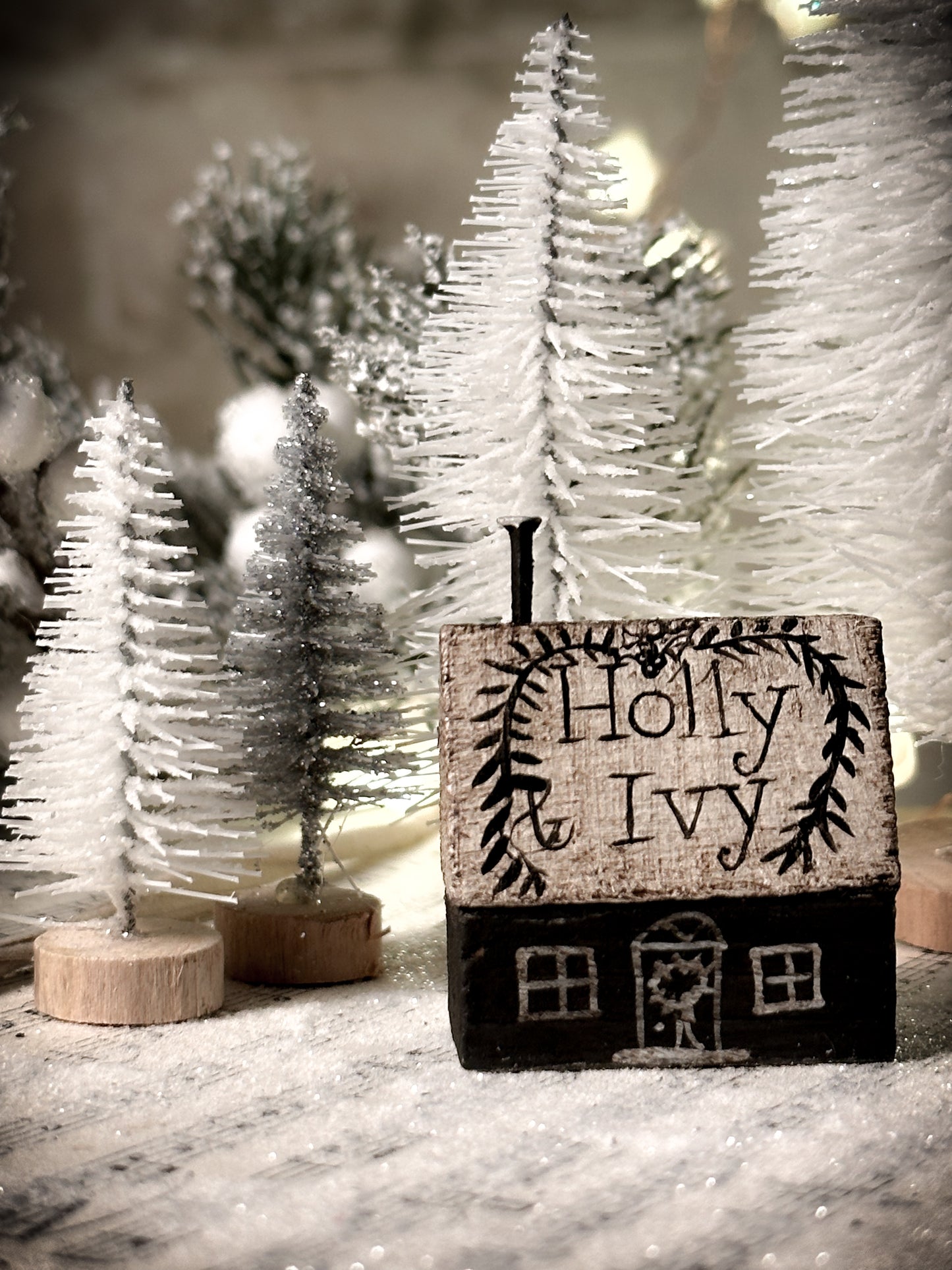 A pretty vintage German Erzgebirge Putz wooden village house painted with a Christmas quote