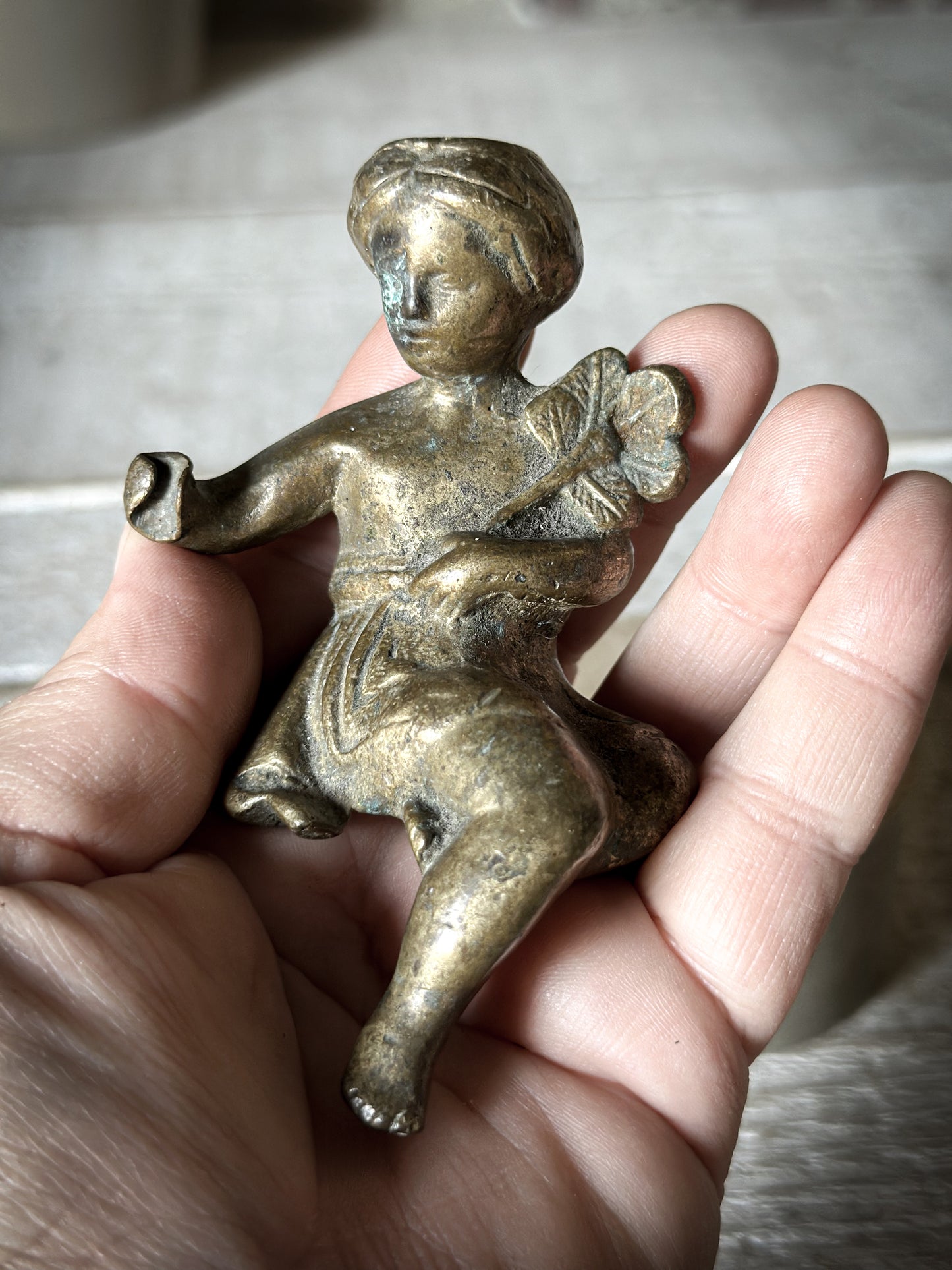 A Delightful Antique Bronze Decorative Seated Cherub