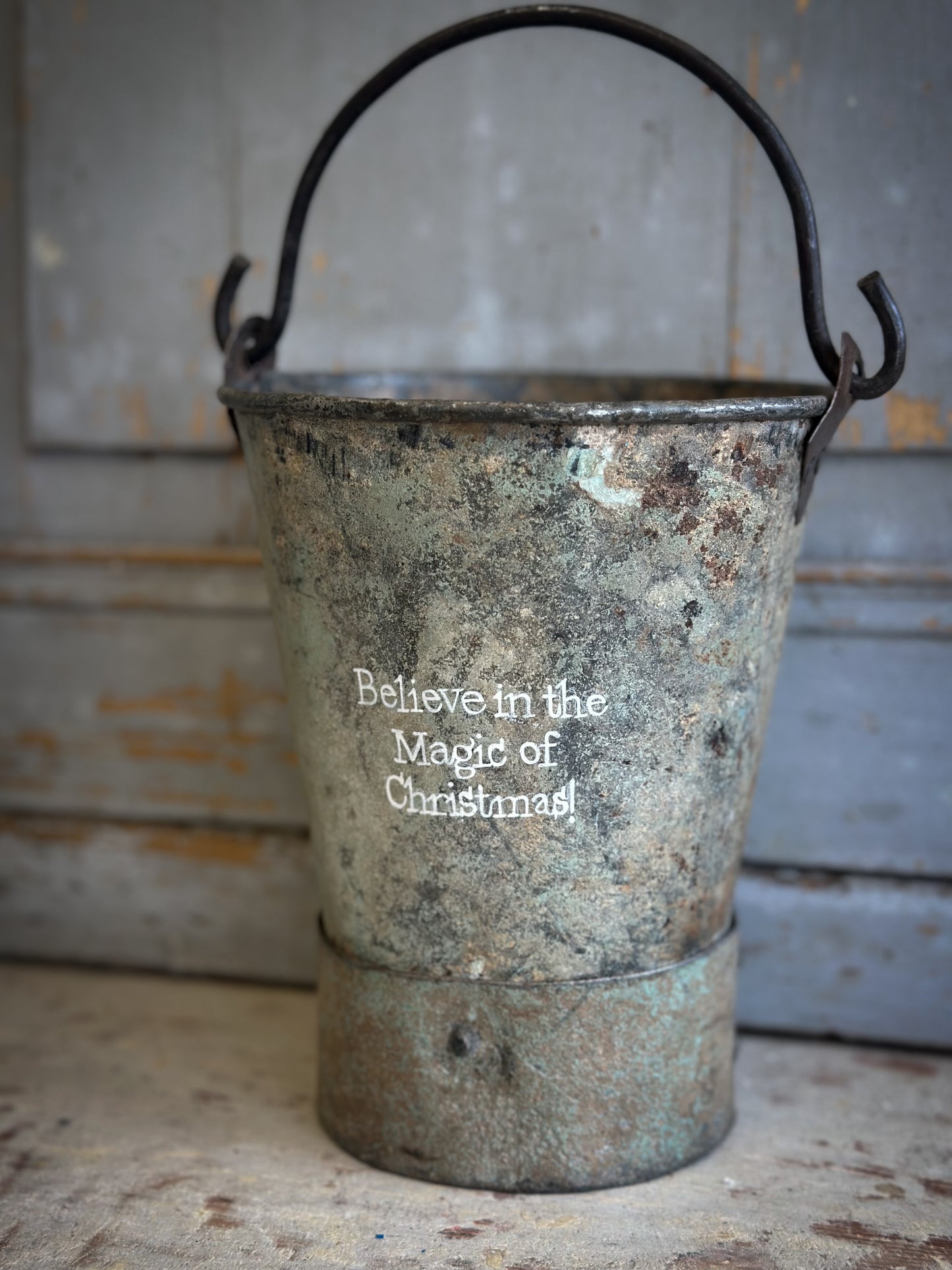 A Recycled Metal Mini Christmas Tree Bucket With A Hand Painted Quote