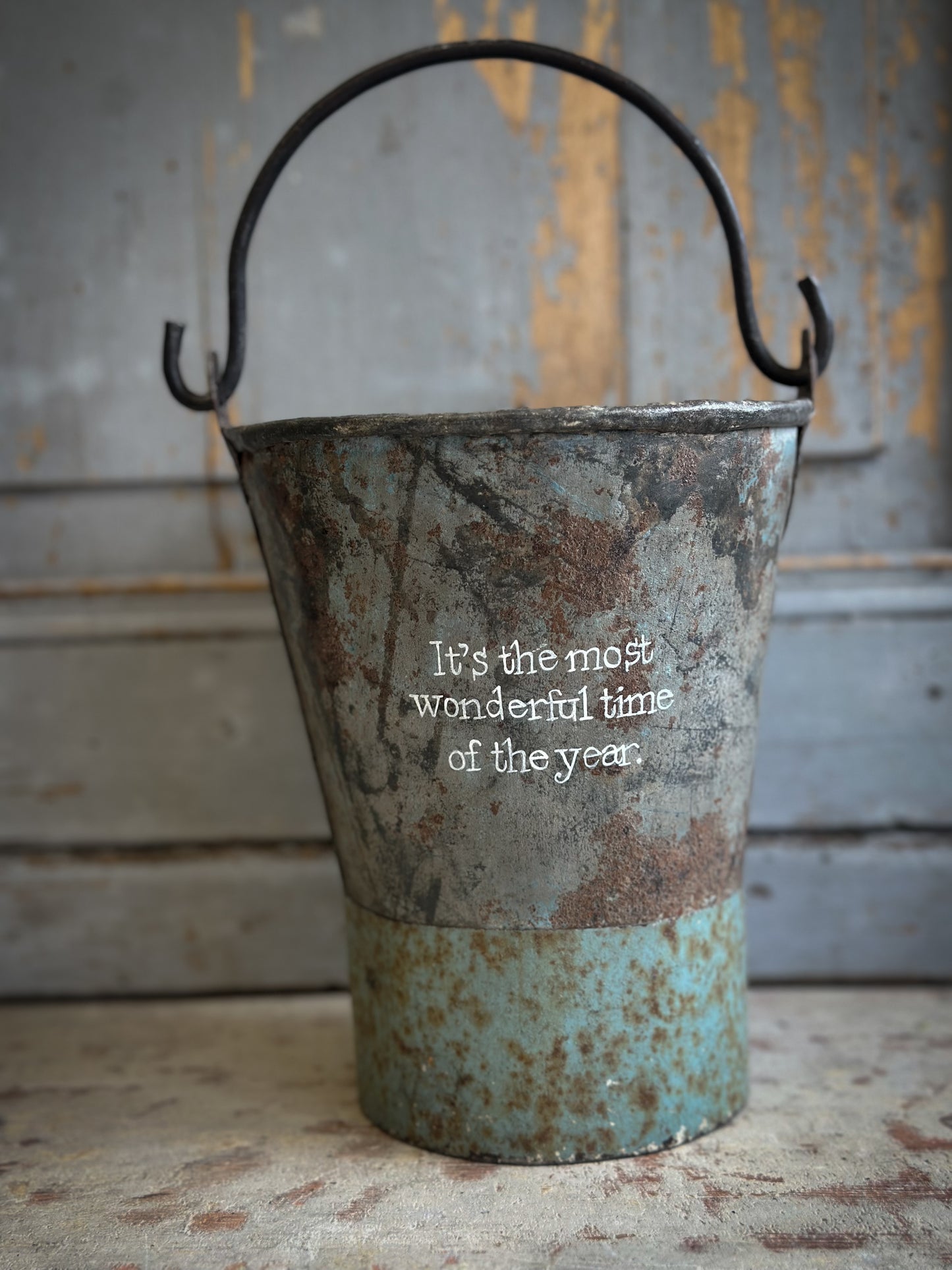 A Recycled Metal Mini Christmas Tree Bucket With A Hand Painted Quote