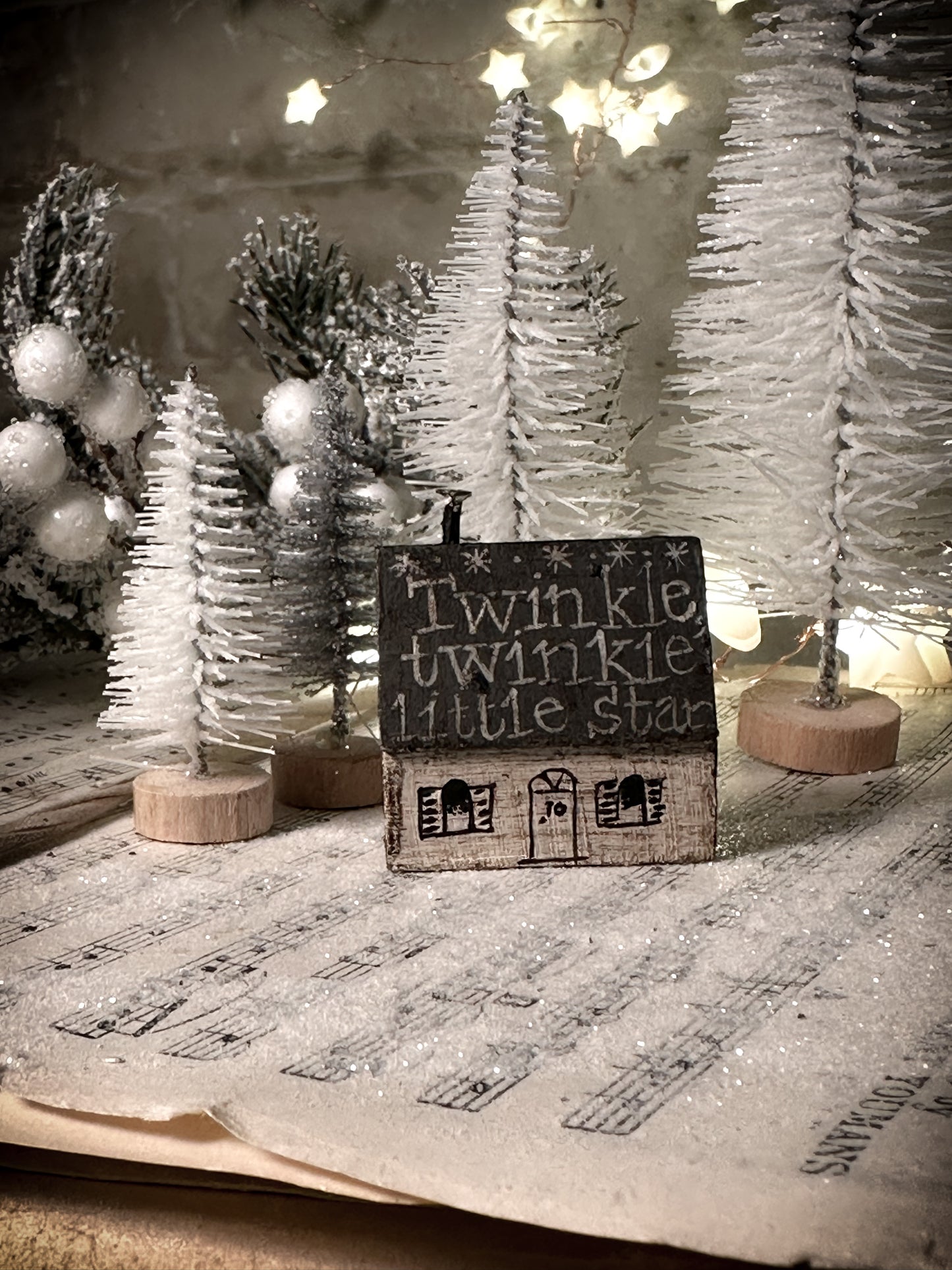 A pretty vintage German Erzgebirge Putz wooden village house painted with a Christmas quote