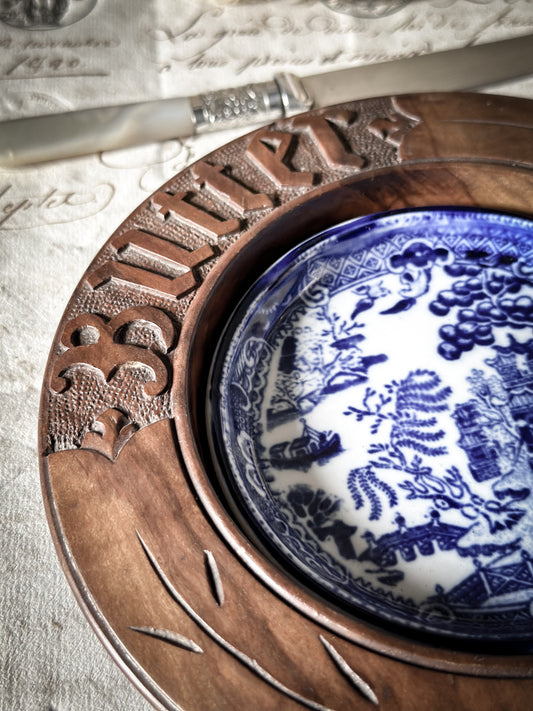 A vintage carved wooden butter tray with Ironstone Willow pattern butter pat dish