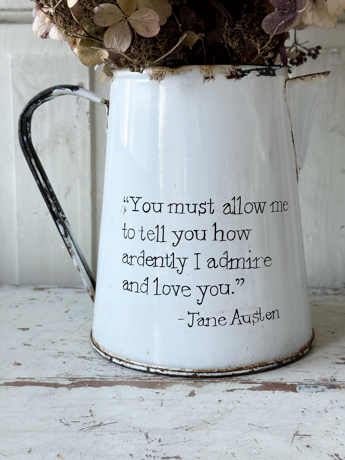 A hand painted quote on a beautiful Vintage white enamelware jug