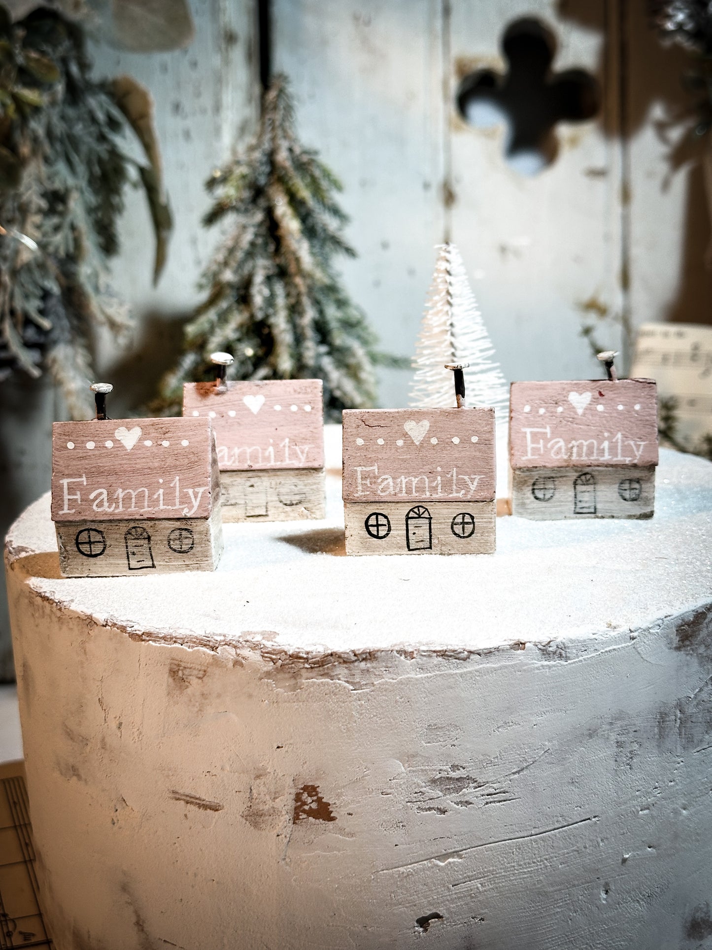 A pretty vintage German Erzgebirge Putz wooden village house painted with a Christmas quote