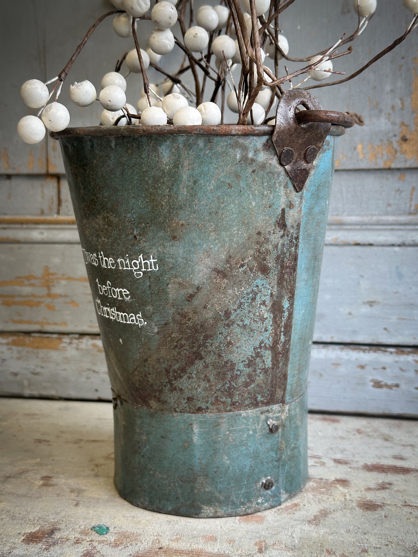 A Recycled Metal Mini Christmas Tree Bucket With A Hand Painted Quote