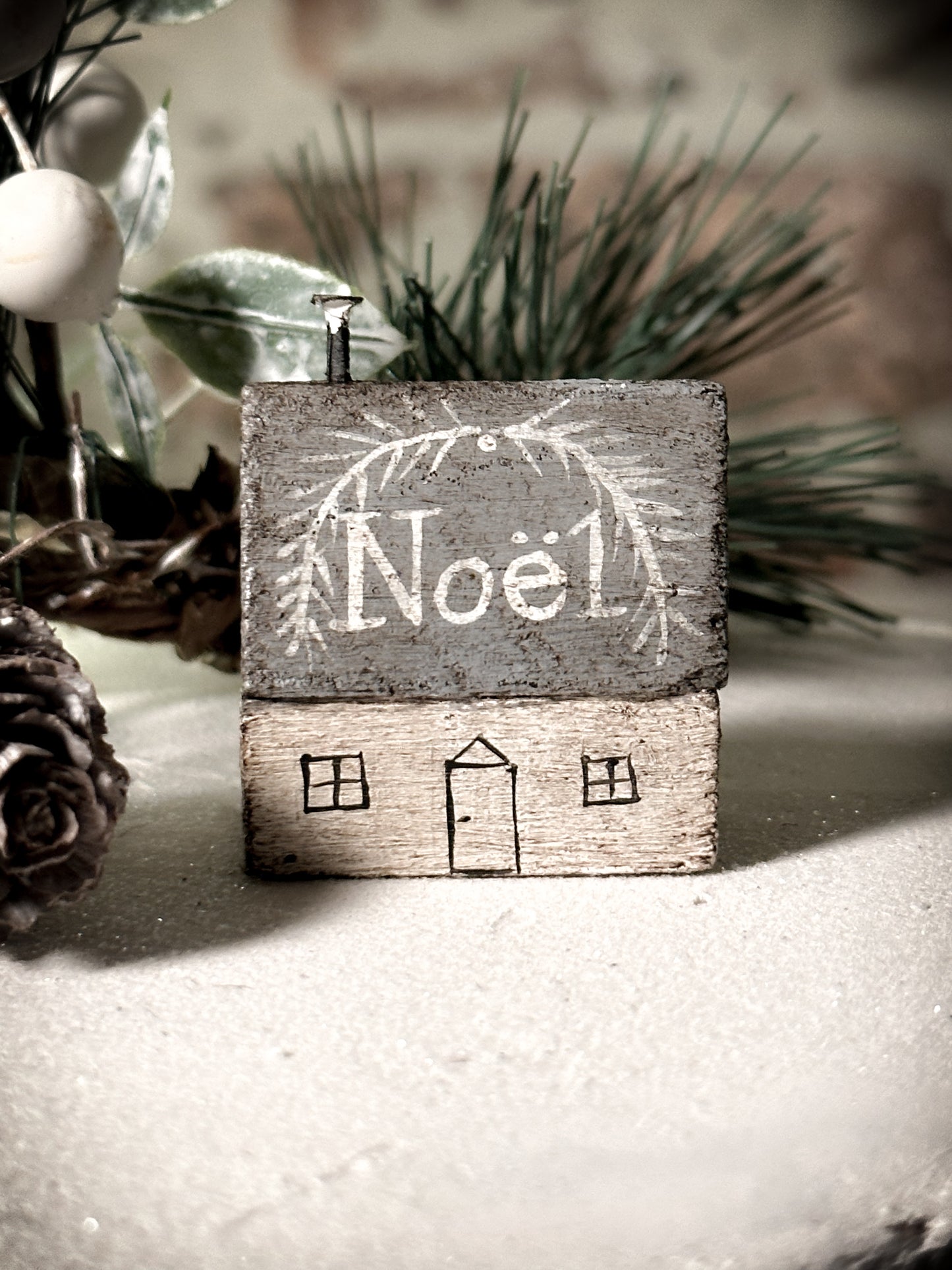 A pretty vintage German Erzgebirge Putz wooden village house painted with a Christmas quote
