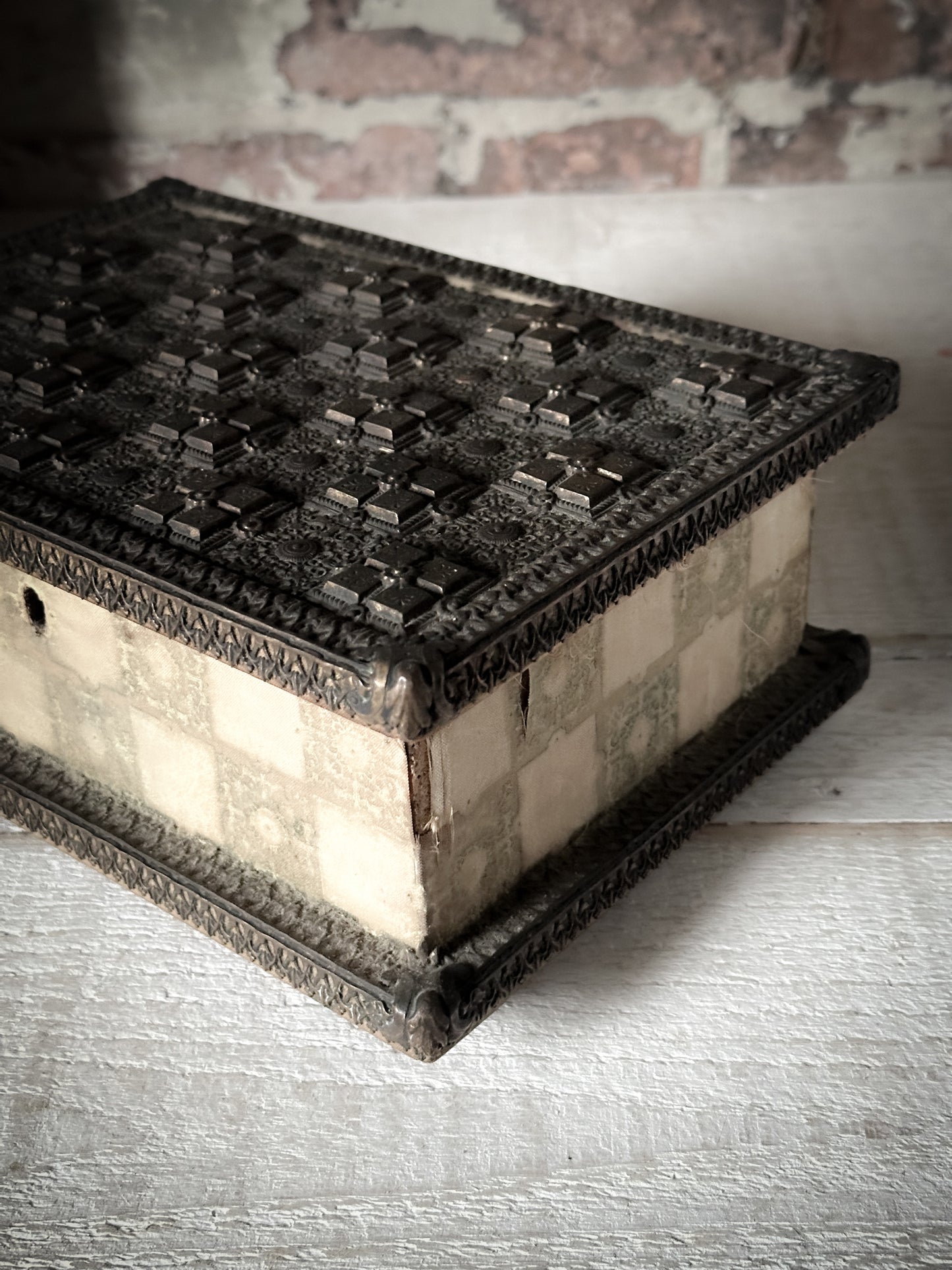 A curious, magical mystery box with medieval beaten metal lid and velvet trim