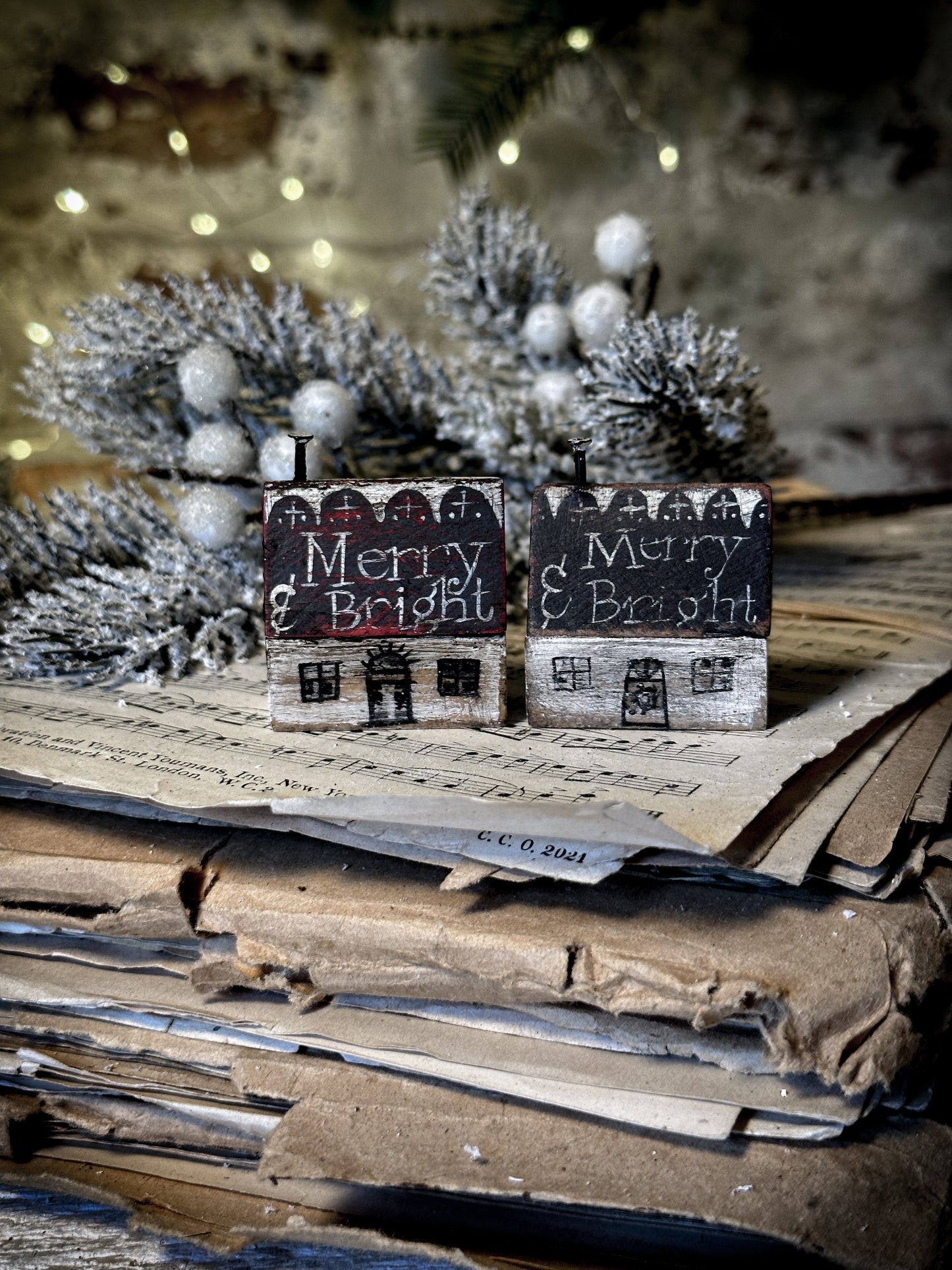 A pretty vintage German Erzgebirge Putz wooden village house painted with a Christmas quote