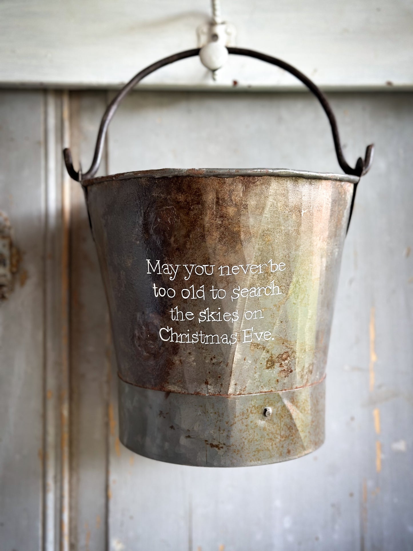 A Recycled Metal Small Christmas Tree Bucket With A Hand Painted Quote