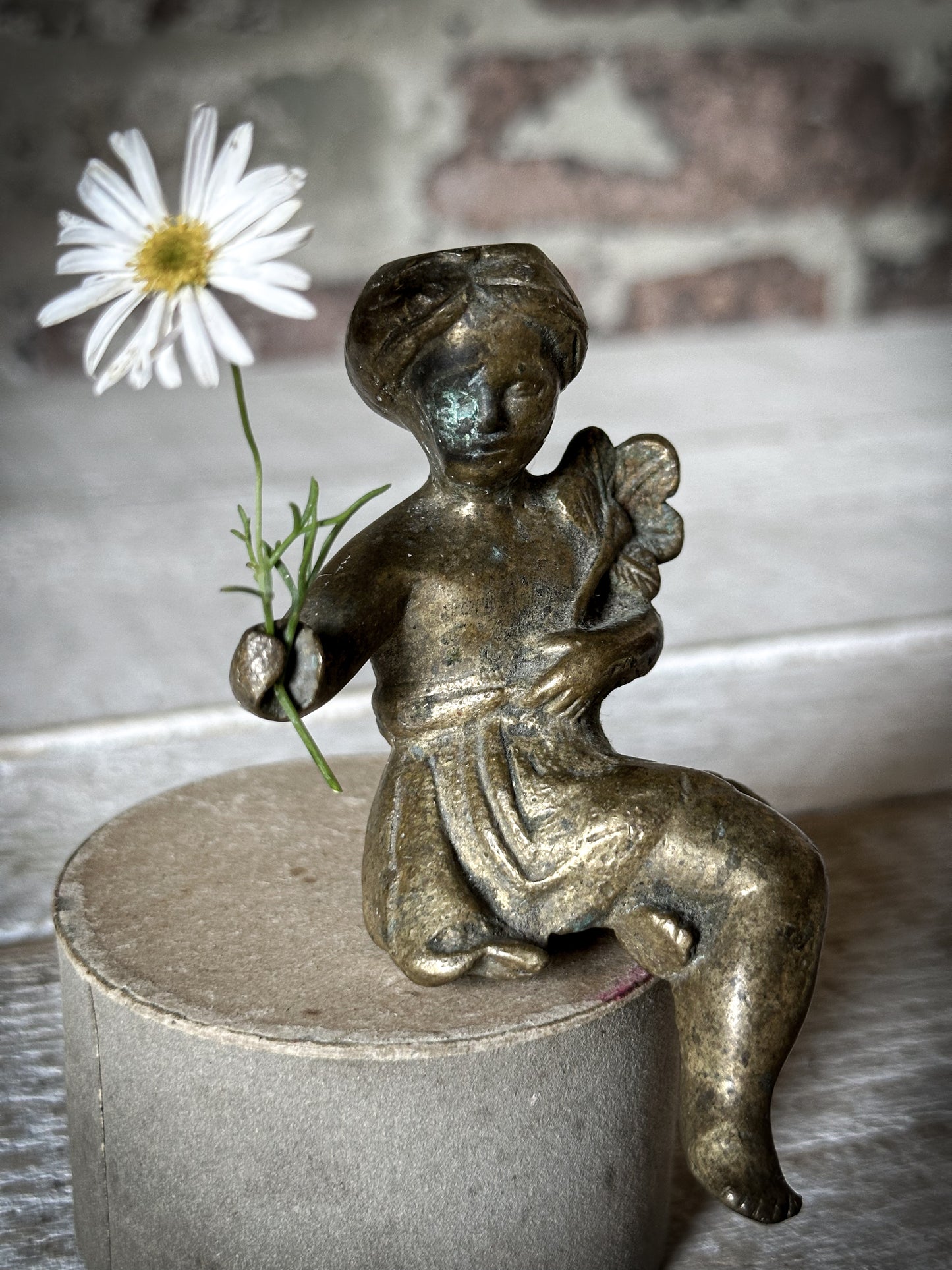 A Delightful Antique Bronze Decorative Seated Cherub