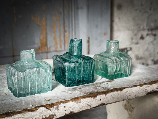 Three antique glass ink bottles for garden pickings