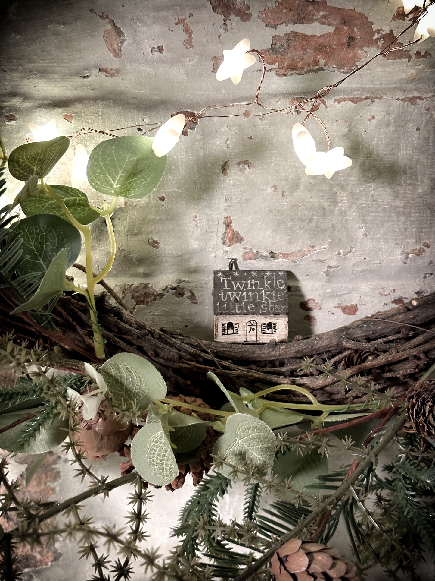A pretty vintage German Erzgebirge Putz wooden village house painted with a Christmas quote