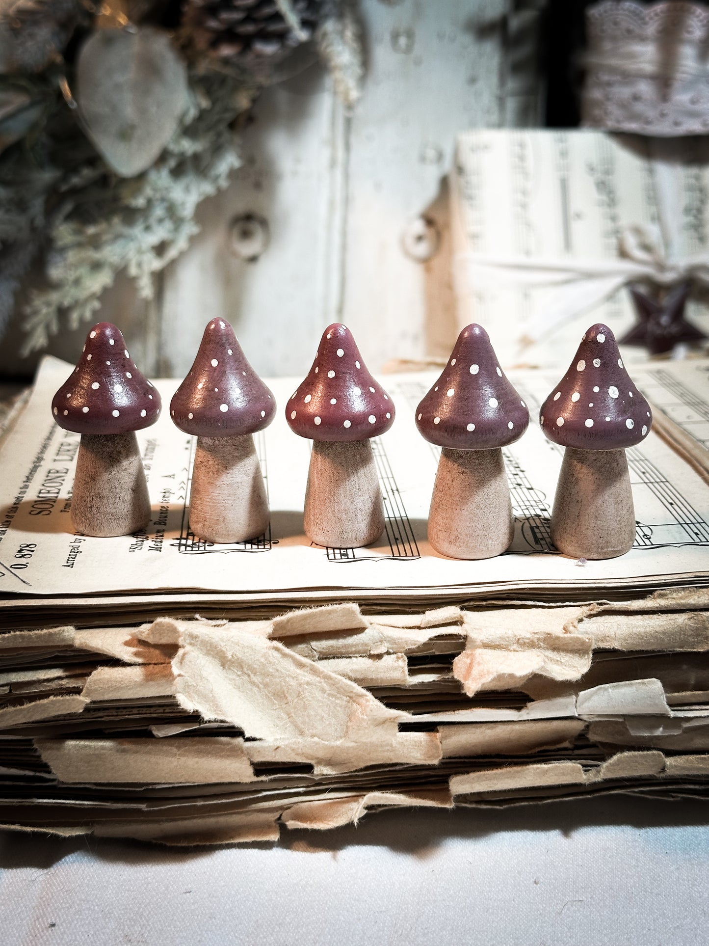 A wooden hand painted Christmas village toadstool