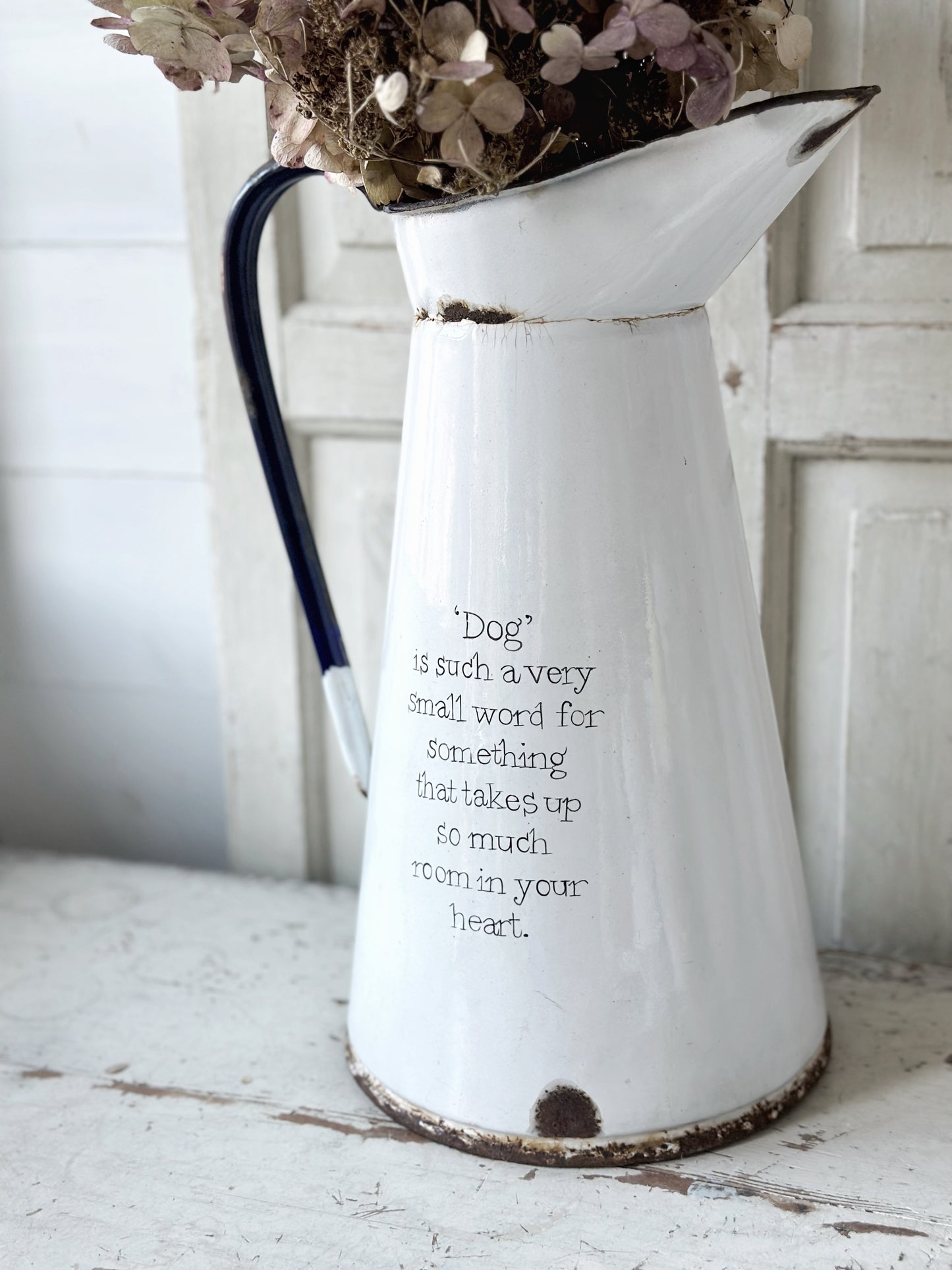 A hand painted quote on a beautiful Vintage white enamelware jug