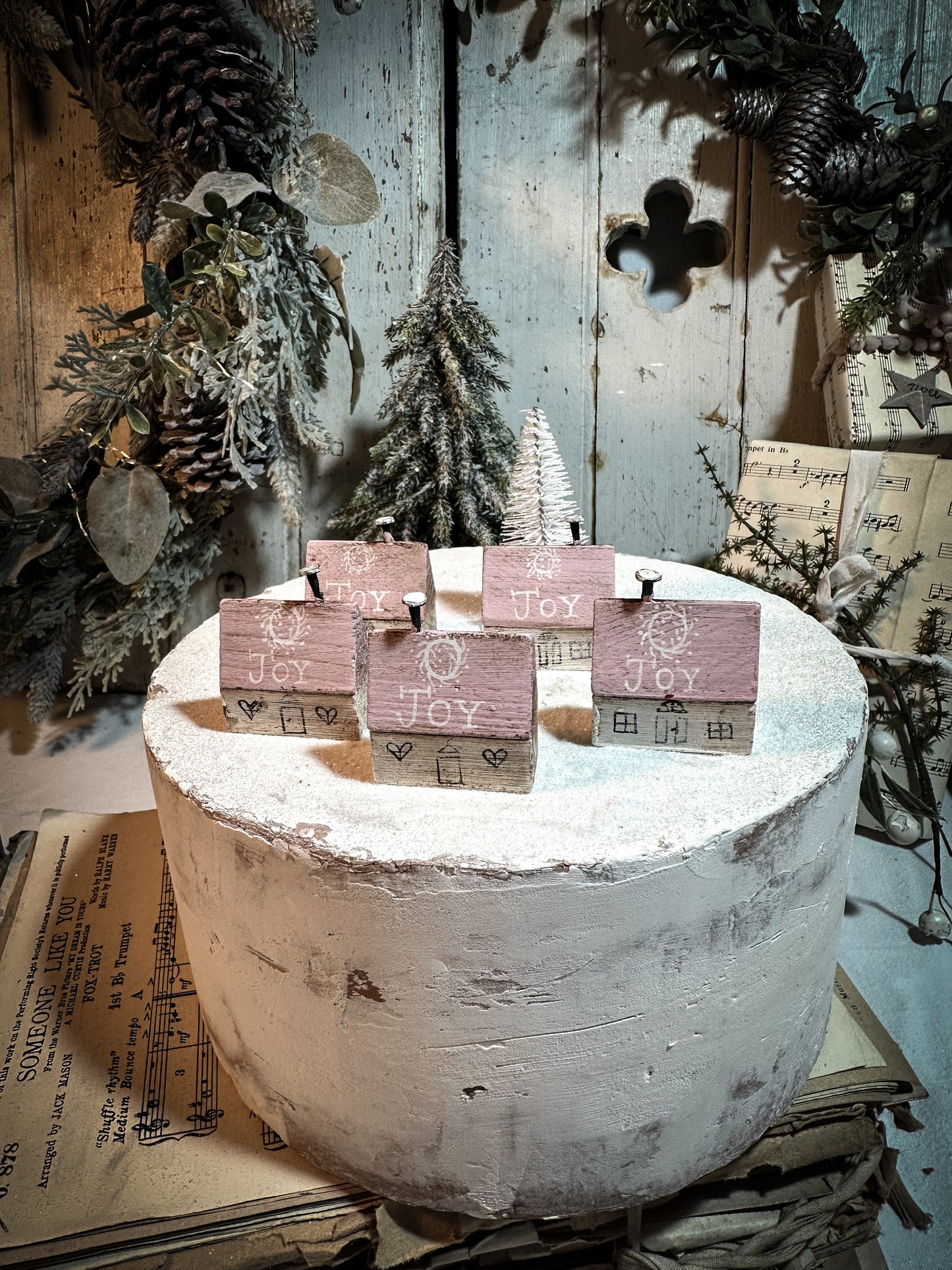 A pretty vintage German Erzgebirge Putz wooden village house painted with a Christmas quote