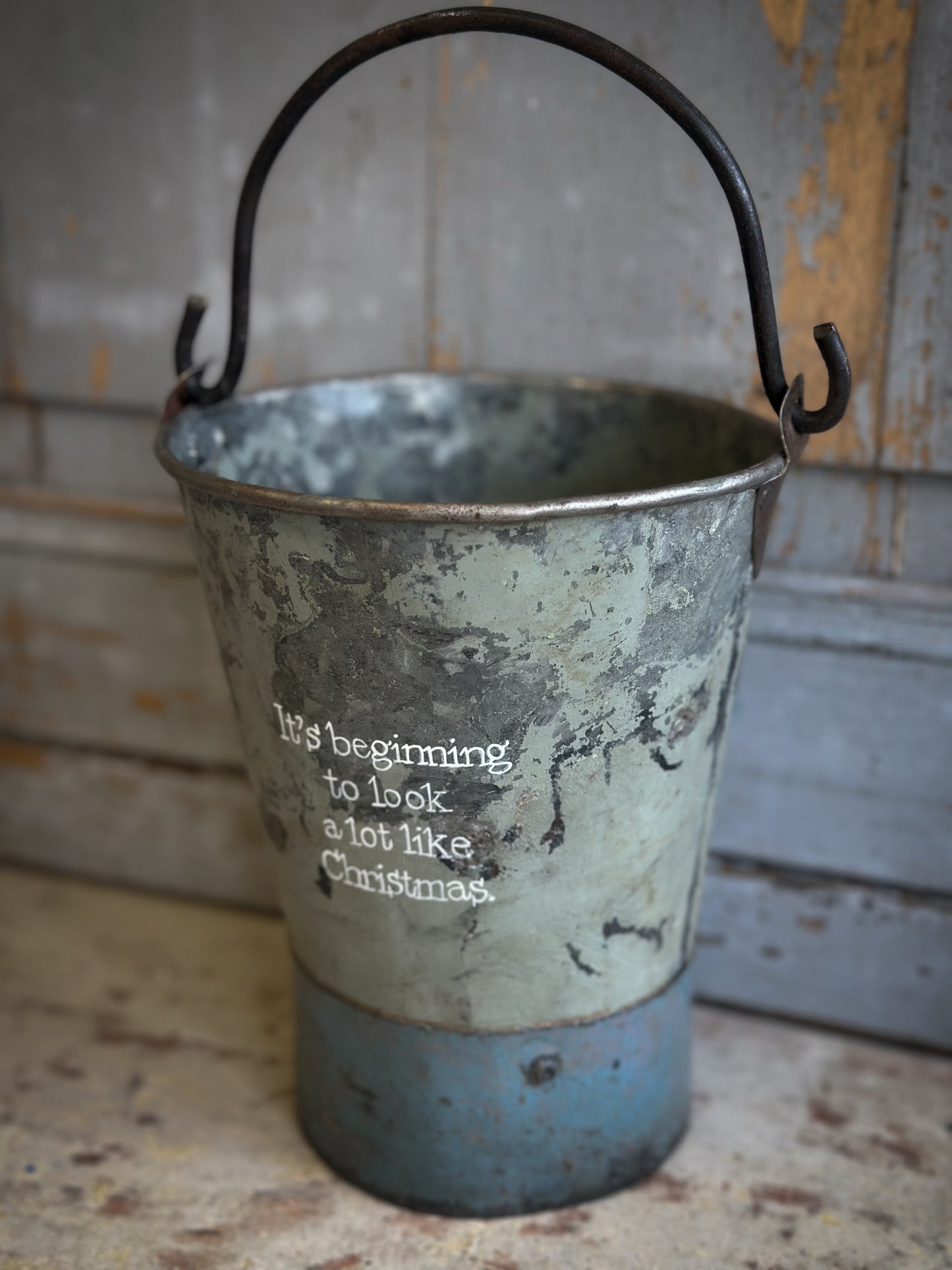A Recycled Metal Mini Christmas Tree Bucket With A Hand Painted Quote