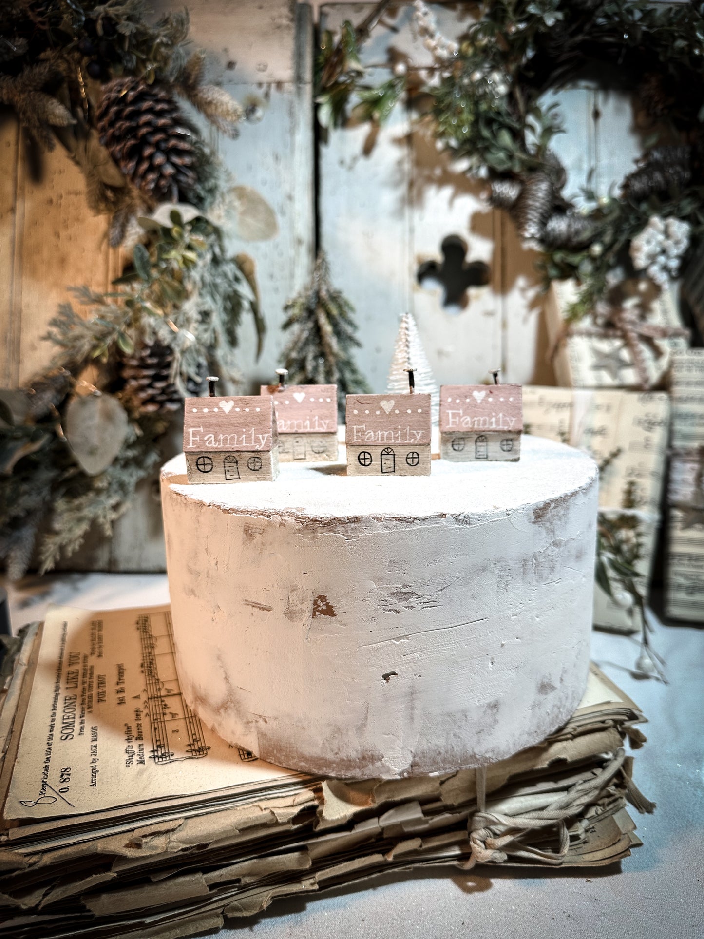 A pretty vintage German Erzgebirge Putz wooden village house painted with a Christmas quote