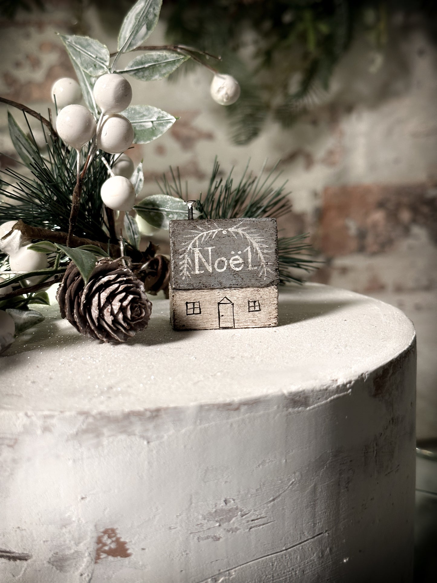 A pretty vintage German Erzgebirge Putz wooden village house painted with a Christmas quote