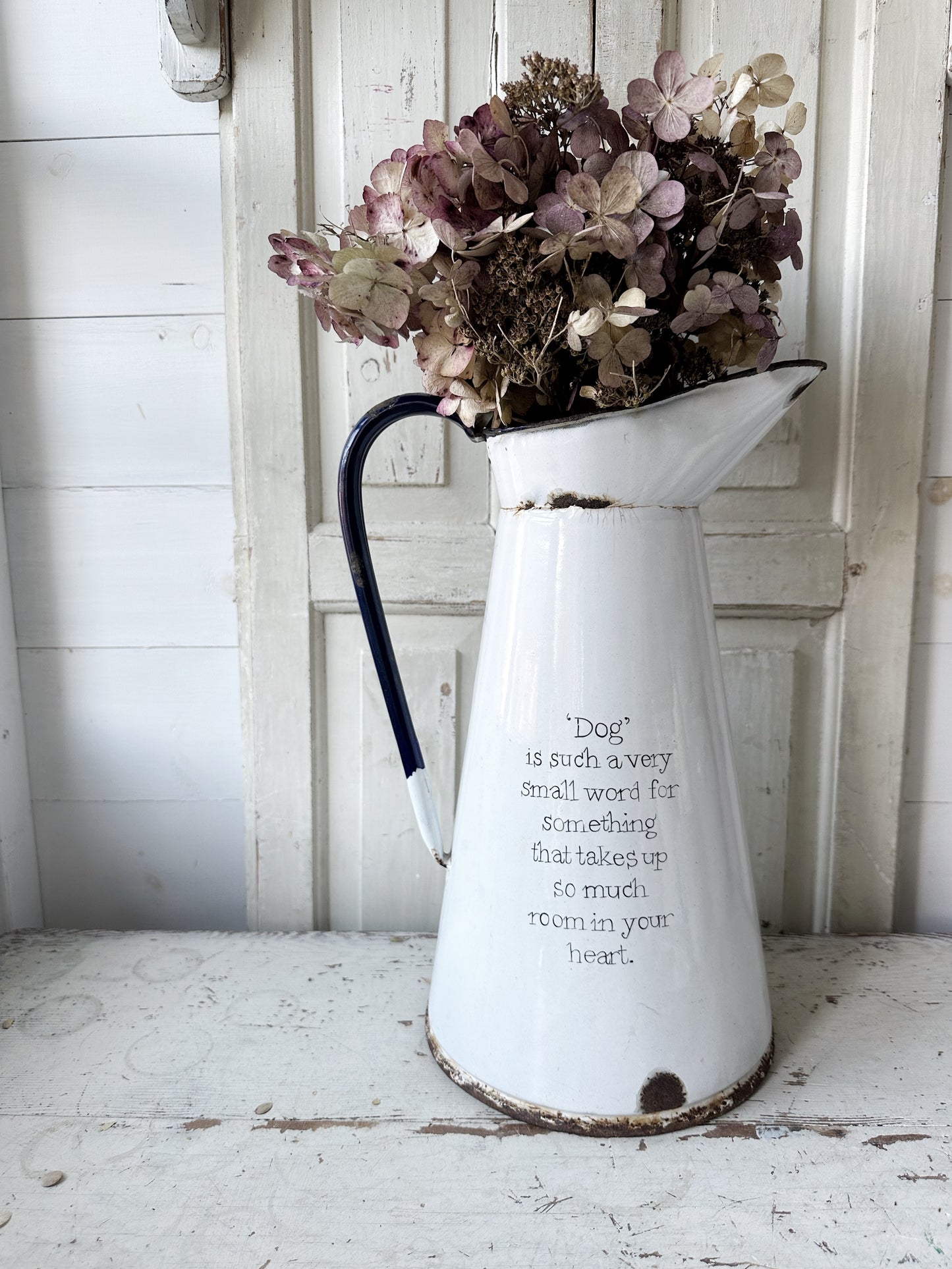A hand painted quote on a beautiful Vintage white enamelware jug